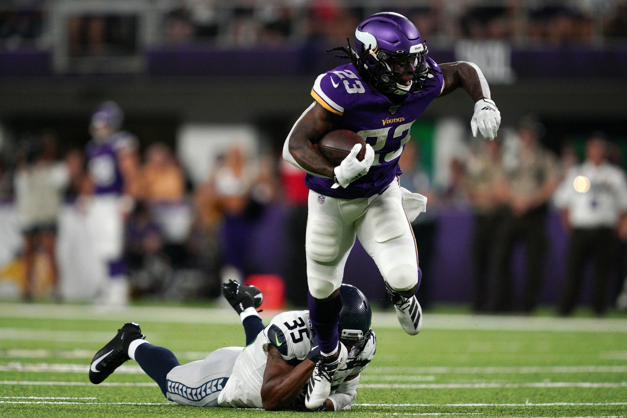 Minnesota Vikings running back Mike Boone (23) dodged the tackle by Seattle Seahawks corner back DeShawn Shead (35) for a 45 yard run in the first half.