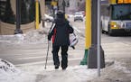 A pedestrian using a cane walked along an icy sidewalk along Central Avenue Northeast in Minneapolis. ] Shari L. Gross &#x2022; shari.gross@startribun