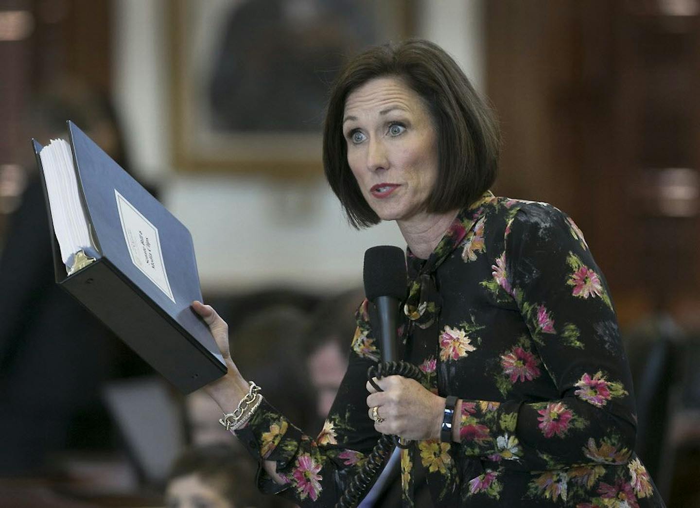 Republican state Sen. Lois Kolkhorst, author of Senate Bill 6, prohibiting transgender-friendly bathrooms, holds a notebook of stories from people during her research on the legislation, as she presents the bill on the floor of the senate for debate at the state capitol in Austin, Texas.