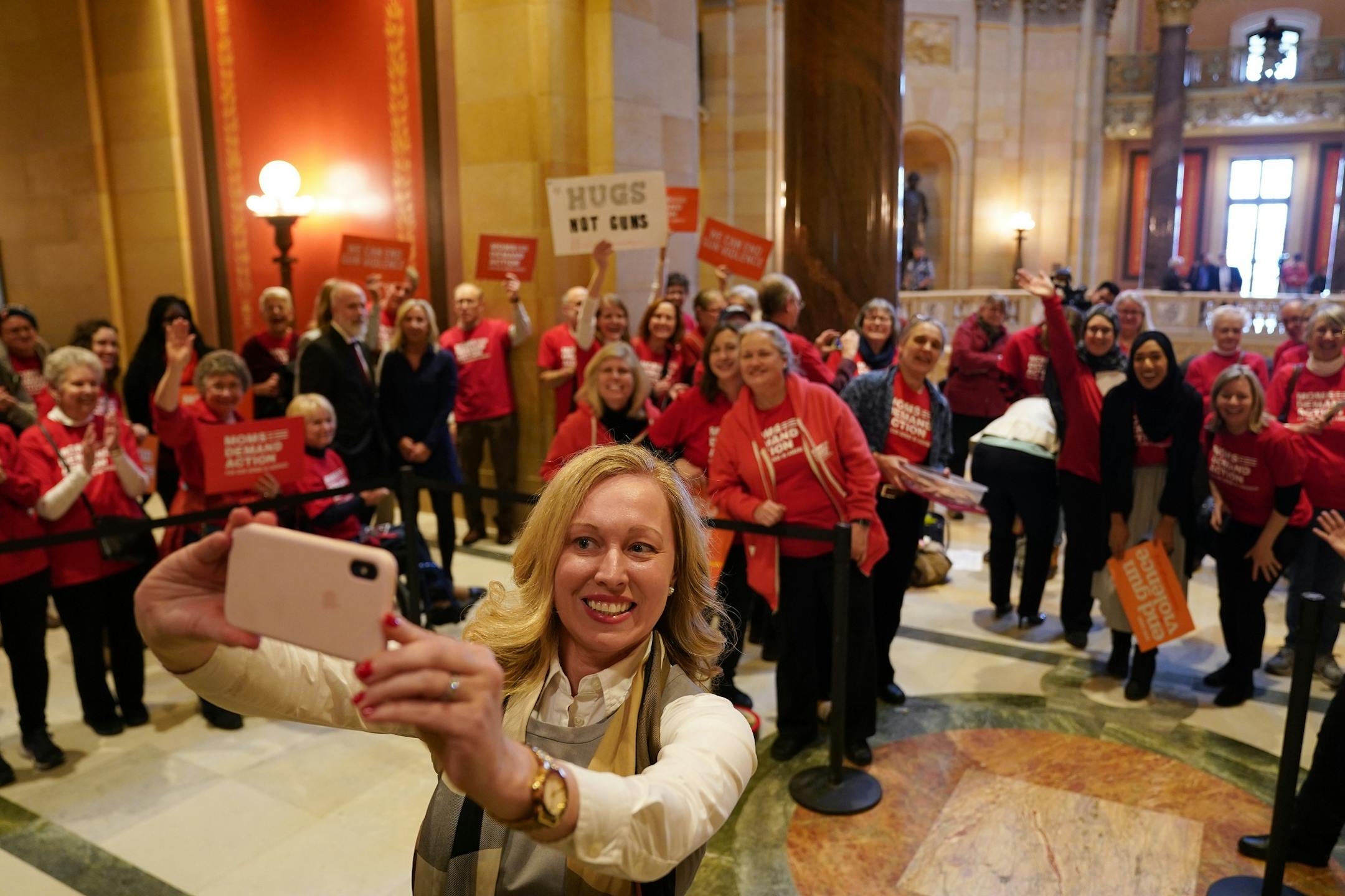 Rep. Heather Edelson (D-Edina) took a selfie with members of the organization Moms Demand Action as they waited to greet state house representatives at the start of the legislative session Tuesday.