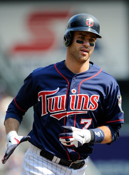 The Twins' Joe Mauer rounded the bases on a solo home run off White Sox pitcher Jake Peavy in the first inning Sunday.