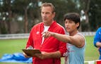 McFARLAND, USA..L to R: Coach Jim White (Kevin Costner) and Thomas Valles (Carlos Pratts). credit: Ron Phillips. Disney 2015