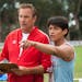 McFARLAND, USA..L to R: Coach Jim White (Kevin Costner) and Thomas Valles (Carlos Pratts). credit: Ron Phillips. Disney 2015
