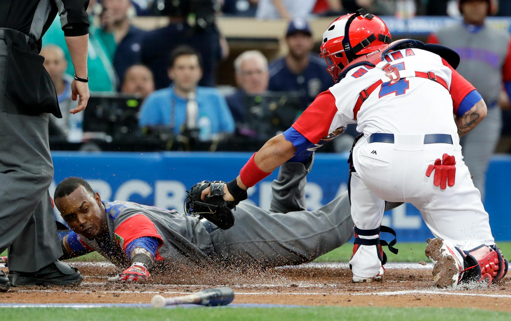 Puerto Rico catcher Yadier Molina (4) tags out Dominican Republic's Jean Segura at home during the first inning of a second-round World Baseball Classic game Tuesday, March 14, 2017, in San Diego. (AP Photo/Gregory Bull)