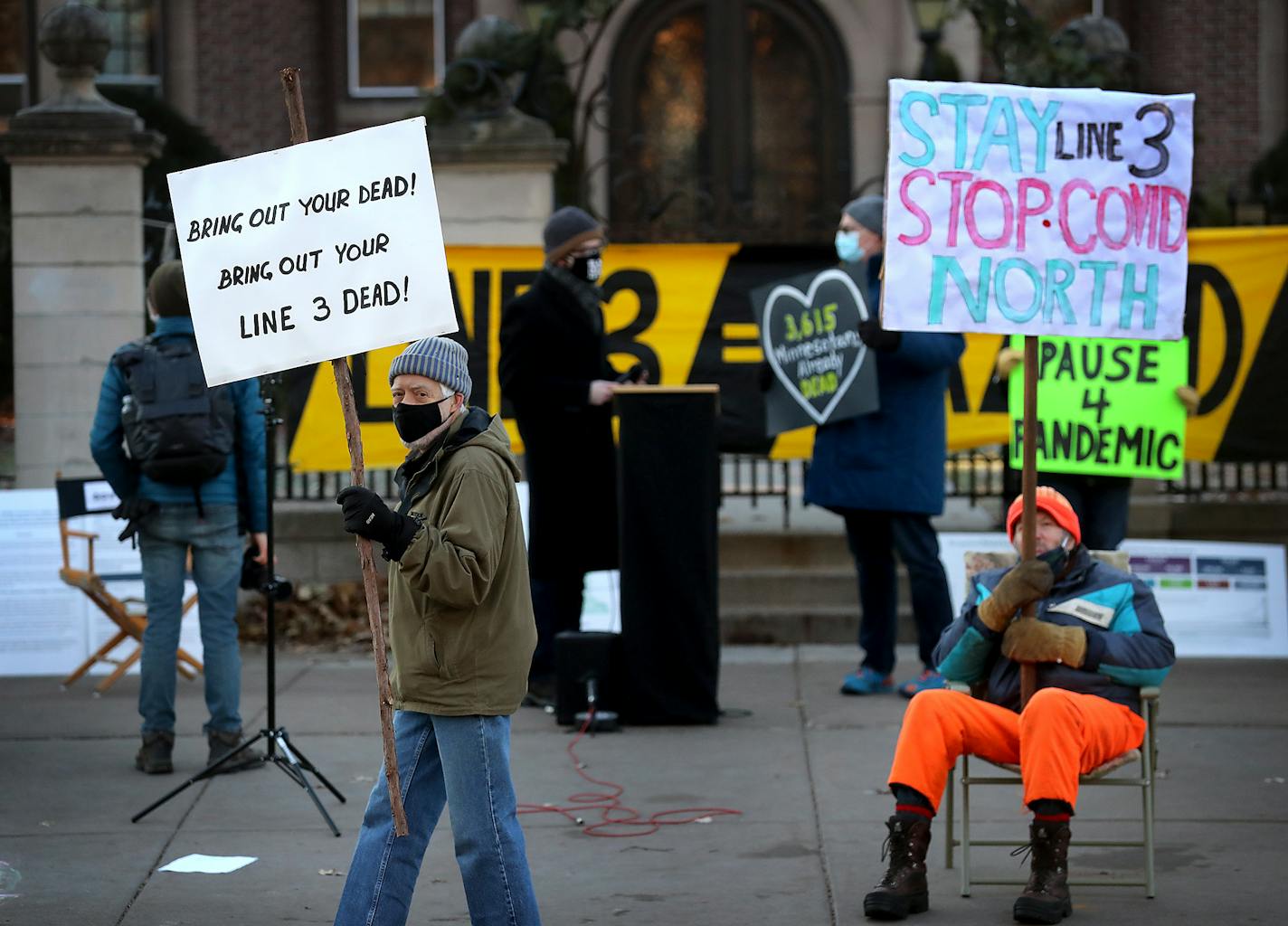 Jerry Striegel of St. Paul, left, and John Munter of Warba held signs during a press conference about concerns around the adequacy of Enbridge's COVID19 plans to begin construction on the Line 3 replacement pipeline and seen Wednesday outside the governor's residence in St. Paul.