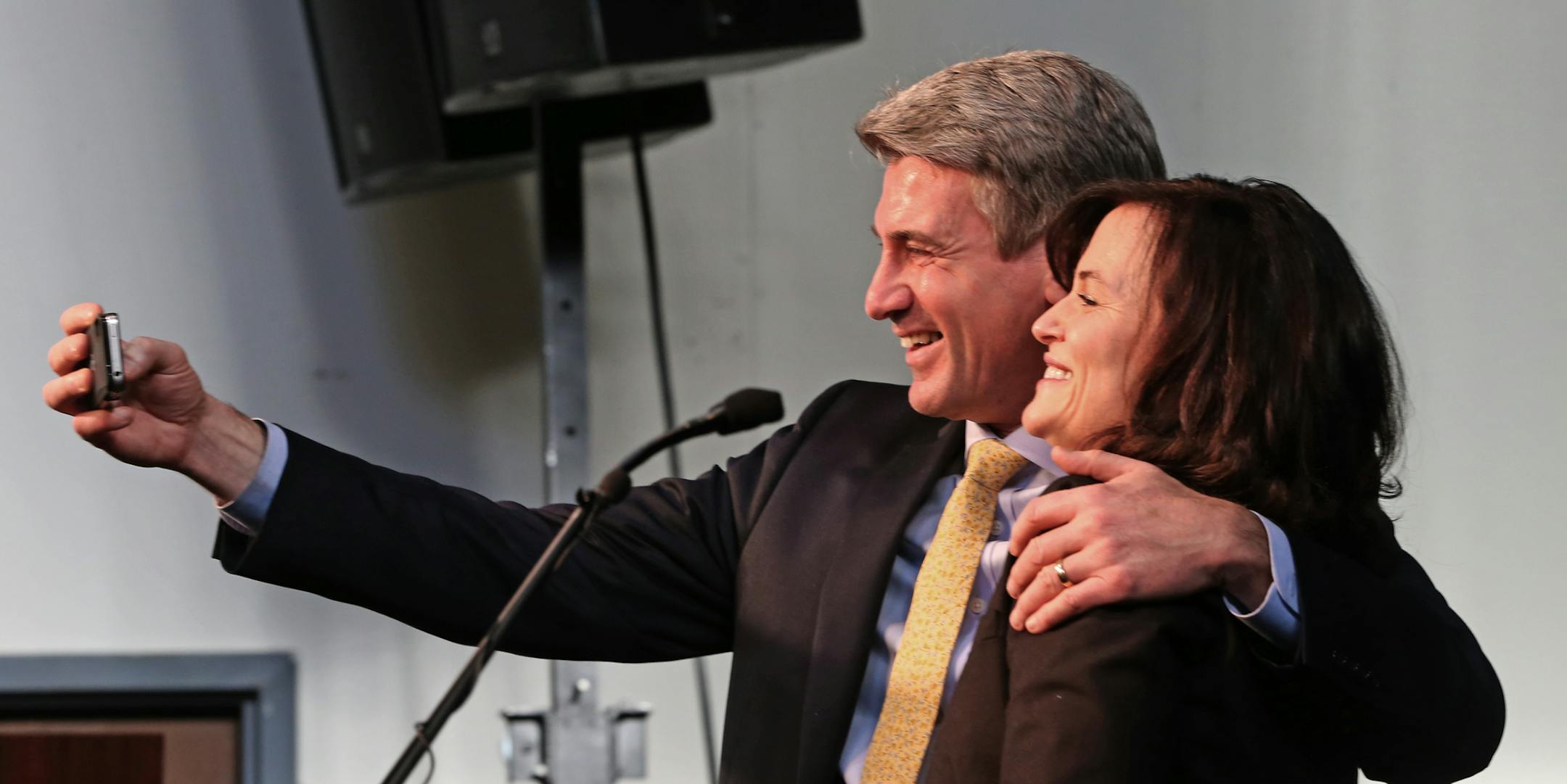 (left to right) Former Minneapolis Mayor R.T. Rybak and new mayor Betsy Hodges took a selfie photo on stage, after she took the oath during her first swearing in ceremony at the Thorp building in North Minneapolis on 1/2/14. Several hundred friends, family and supporters attended the ceremony. Hodges' formal swearing in (where she will give her inaugural speech) is Monday, Jan. 6. Under city charter, she is required to be sworn in on the first business day of January, which is Jan. 2.] Bruce Bis