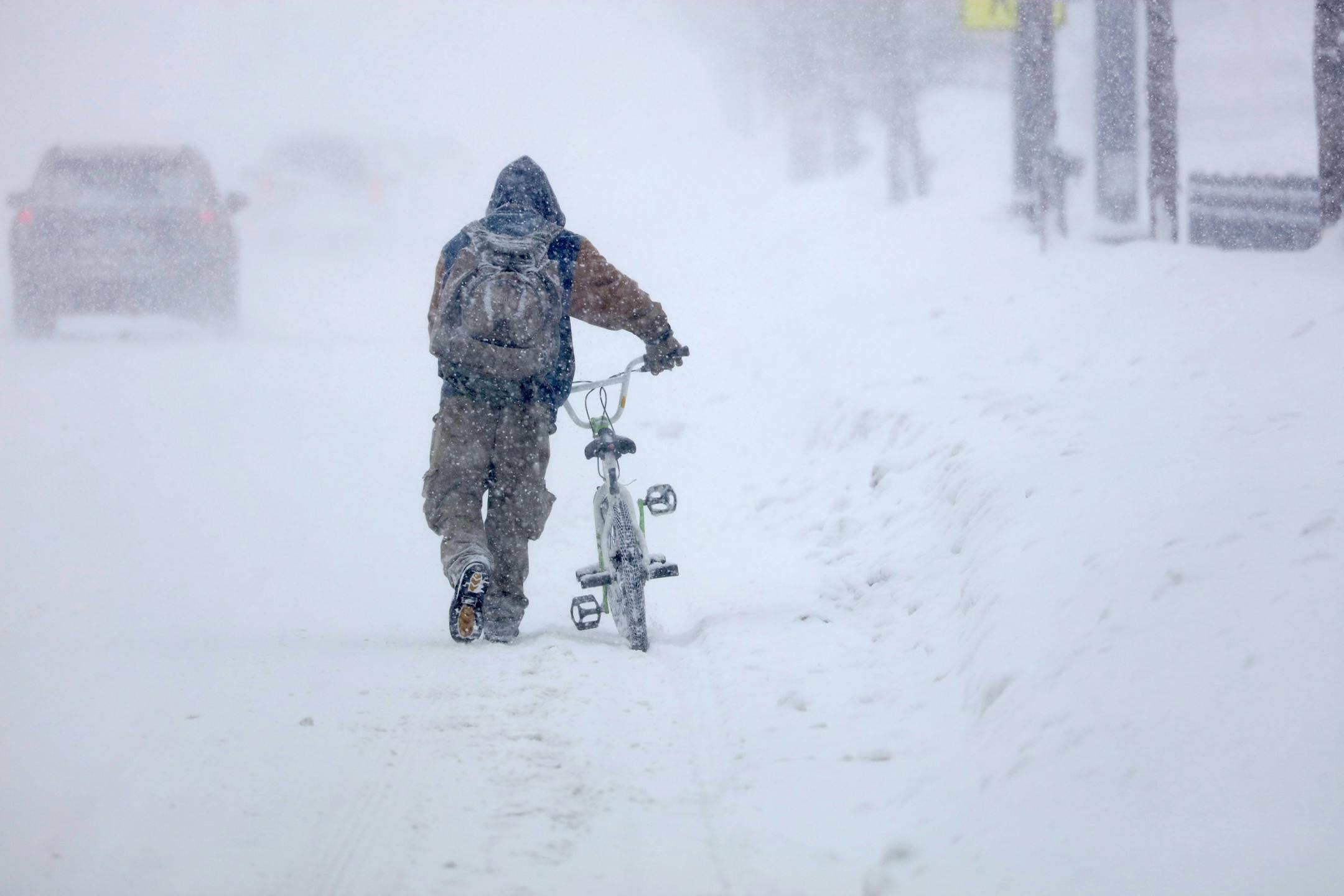 Austin Tauber headed home in Anoka with his bicycle Wednesday morning. The snow prevented him from being able to ride.