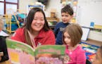 Reading Corps tutor Bau Xiong kept young readers engrossed at Earle Brown Elementary/Brooklyn Center School Readiness.
