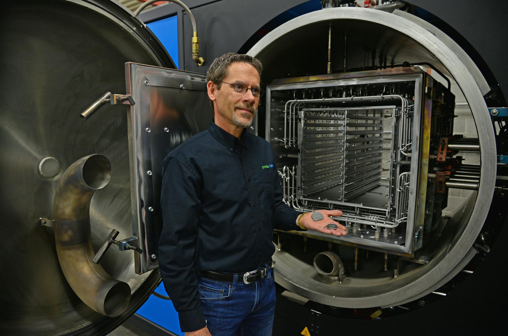 Bill Dietrick, Proto Labs Vice President of Marketing talked about the capabilities of this furnace on the manufacturing floor. ] Proto Labs invested $3 million and now will offer steel and rubber injection molding services in addition to its traditional plastic contract-manufacturing work. New business division will be in Maple Plain, Minn Richard.Sennott@startribune.com Richard Sennott/Star Tribune Maple Plain Minn. FRiday 4/11/2014) ** (cq)