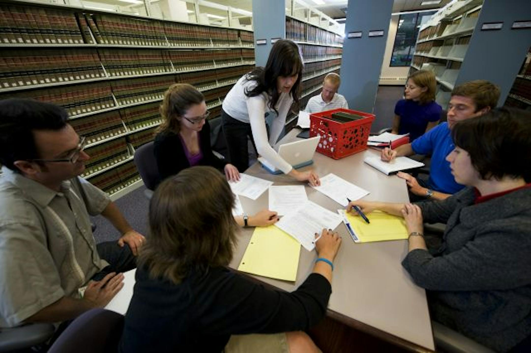 Meeting in the Law Library, several law students met to plan for William Mitchell's new Pro Se legal clinic, which will teach lay people how to best represent themselves in court. (L. to R around table) Will Crain, Krista Schneider(left most), Sarah McBroom, Andrew Sundboom, Megan Gaudette, Adam Pabarcus, Jen Cooklock, and Emily Babcock (back to camera).