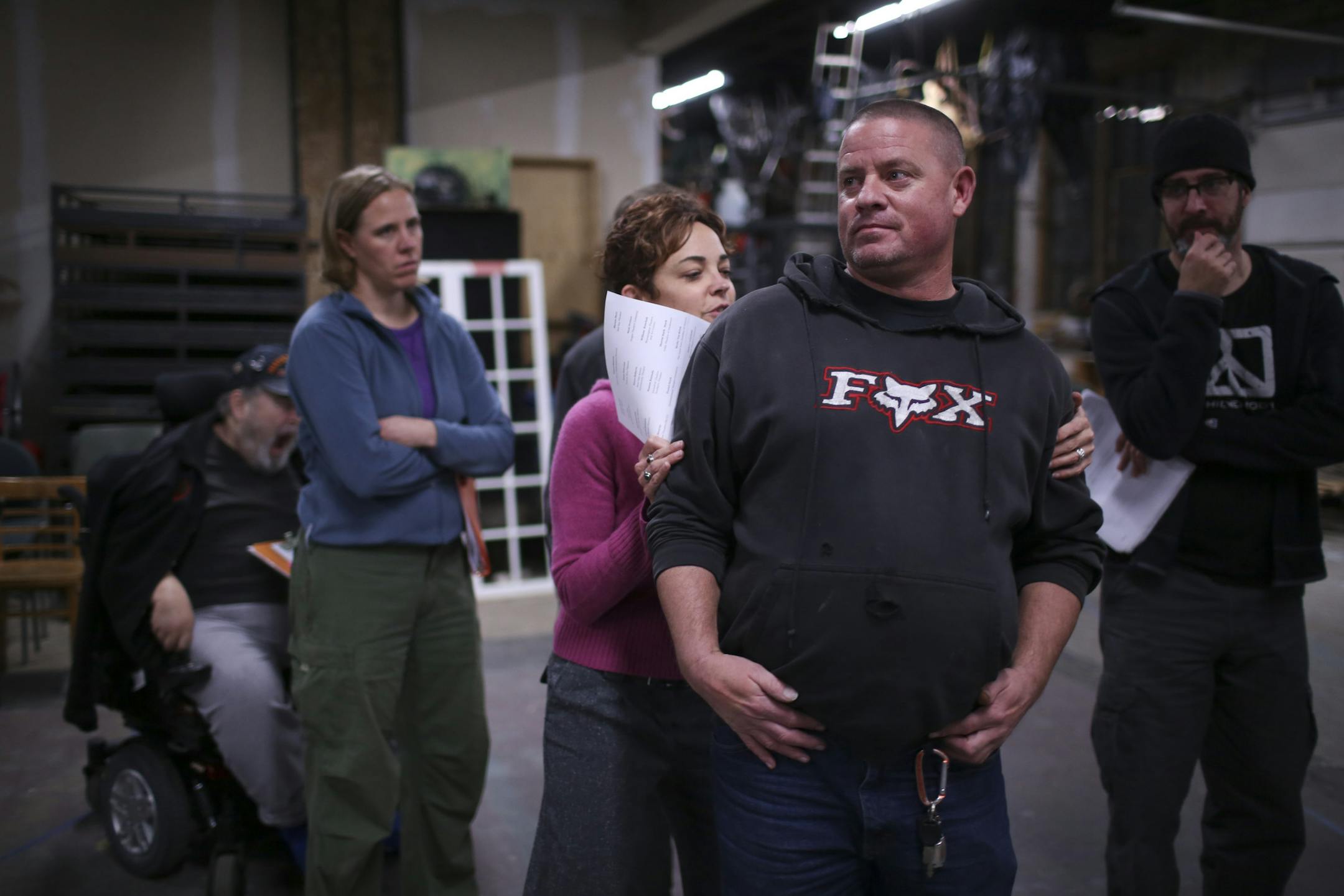 Director Leah Cooper moved Matt Delaney into position at rehearsal. The project brings together military personnel and theater pros.
