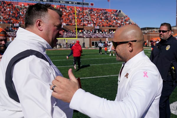 Gophers coach P.J. Fleck, right, congratulated Illinois coach Bret Bielema after the Illini defeated Minnesota 26-14 on Saturday in Champaign.