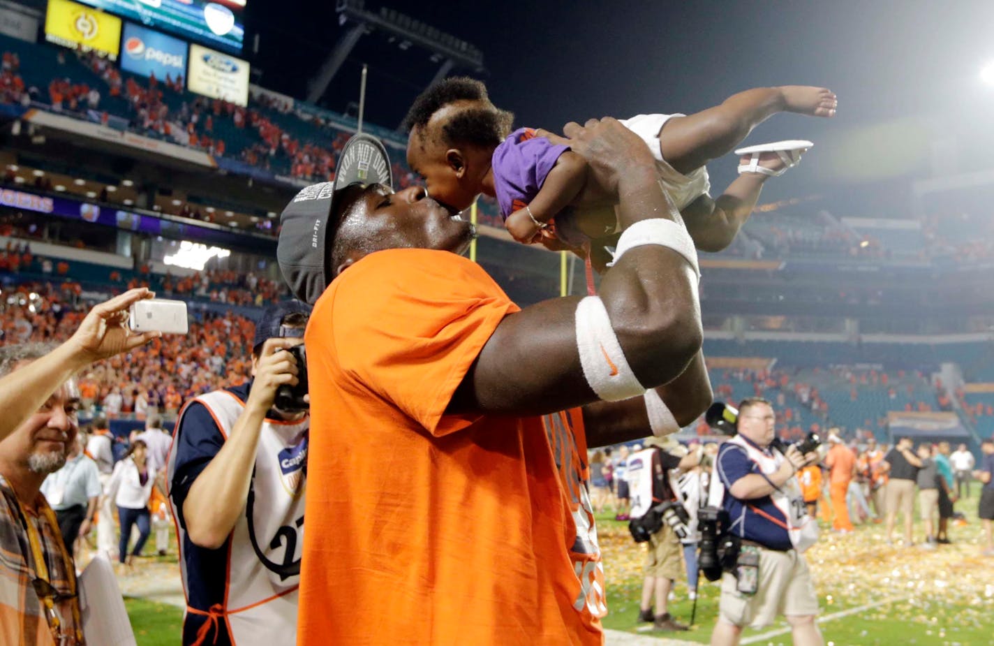 Clemson safety Jayron Kearse kissed his daughter, Ja'riah, after the Tigers won the Orange Bowl NCAA college football semifinal playoff game against Oklahoma 37-17 on Dec. 31, 2015.