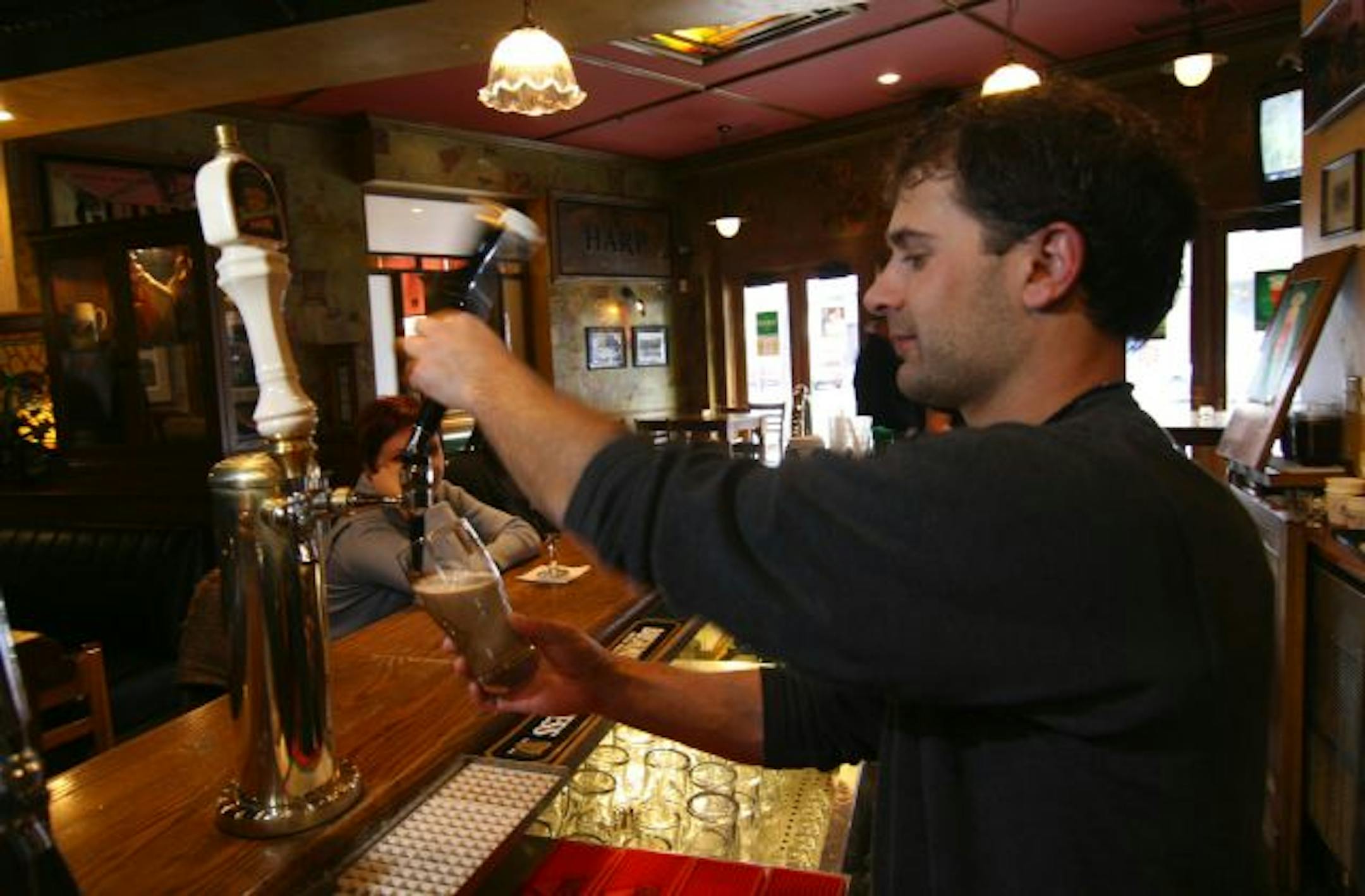 O'Donovan's Irish Pub, bartender Grant Fobel demonstrates how to do a 'proper pour' - they have a certificate from Guiness attesting to it... it's pulled in several stages and allowed to settle, may take 2 minutes before ready to drink.