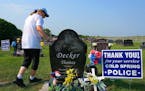 Rosella Decker, the mother of Tommy Decker, who was shot to death while working as a Cold Spring police officer in November 2012, put a hand on his gr