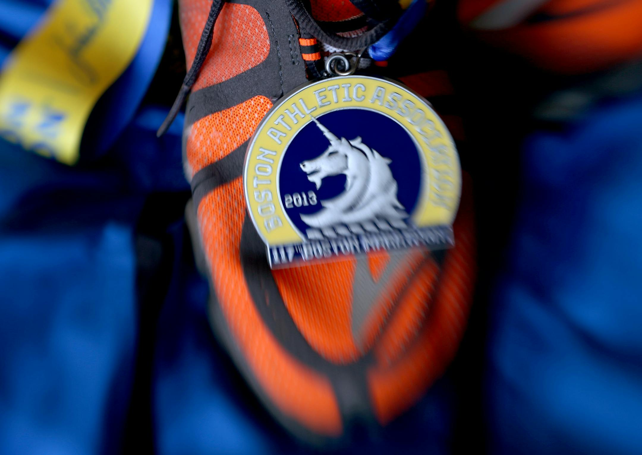 Boston marathon qualifier Mike Johnson ran last year's Boston Marathon in these orange shoes. He plans to run in them again this year. Photographed in studio, Friday, March 14, 2014. ] (ELIZABETH FLORES/STAR TRIBUNE) ELIZABETH FLORES • eflores@startribune.com ORG XMIT: MIN1403191348350617 ORG XMIT: MIN1404092149190724