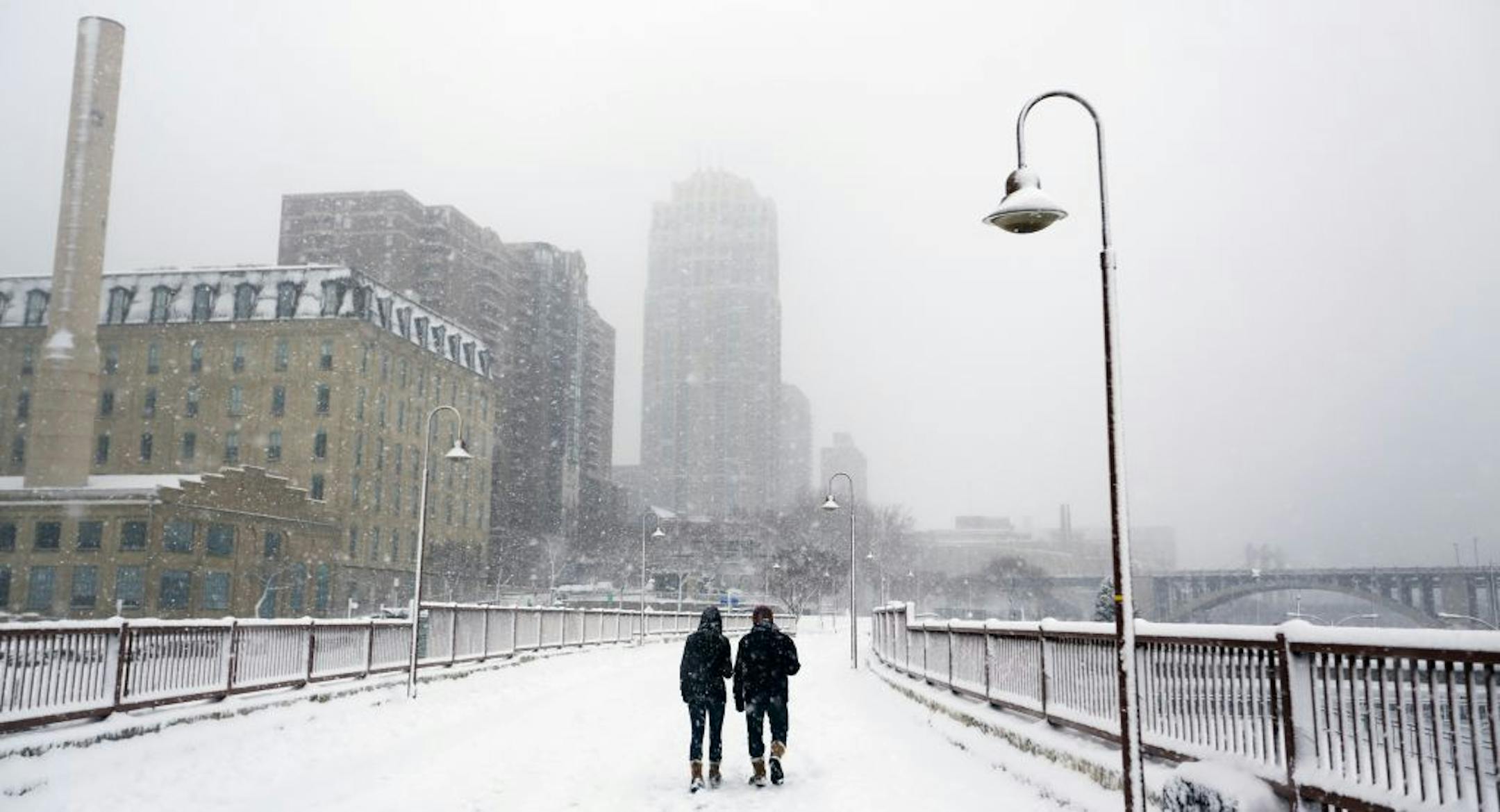 In Minneapolis on the Stone Arch Bridge, pedestrians enjoyed the snow.