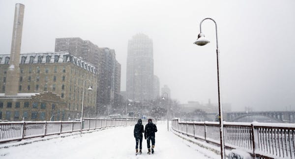In Minneapolis on the Stone Arch Bridge, pedestrians enjoyed the snow.