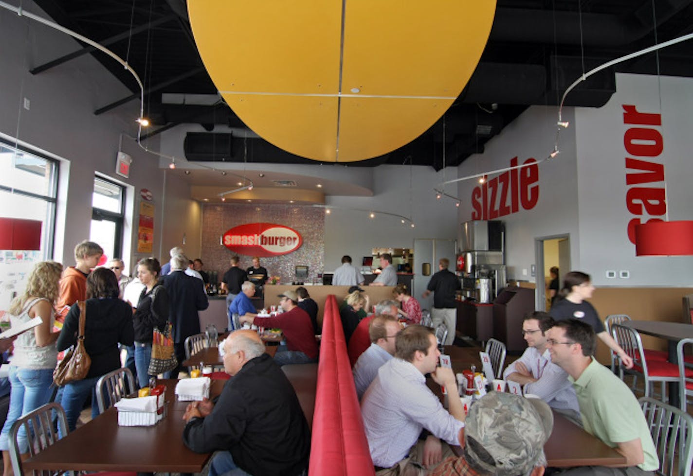 A busy lunch hour with a line of people waiting to order at the newly opened Smashburger in the St. Anthony Village shopping area.