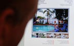 A man views a property for sale on a website advertising the former home of actress Marilyn Monroe, which was the scene of her death in the Brentwood 