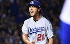 Los Angeles Dodgers pitcher Yu Darvish celebrates after the Chicago Cubs' John Jay grounded into a double play in the sixth inning during Game 3 of th