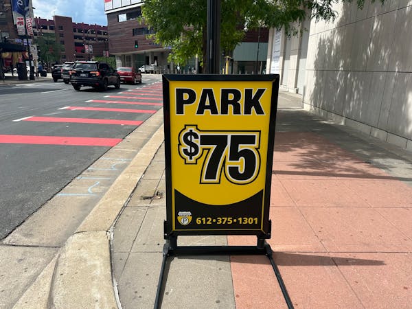 A sign shows the steep cost to park at the Mayo Clinic Square Ramp in downtown Minneapolis for the Timberwolves game Wednesday night.