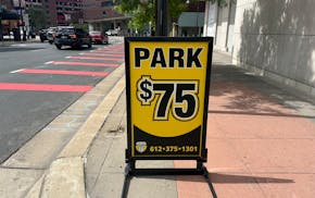 A sign shows the steep cost to park at the Mayo Clinic Square Ramp in downtown Minneapolis for the Timberwolves game Wednesday night.