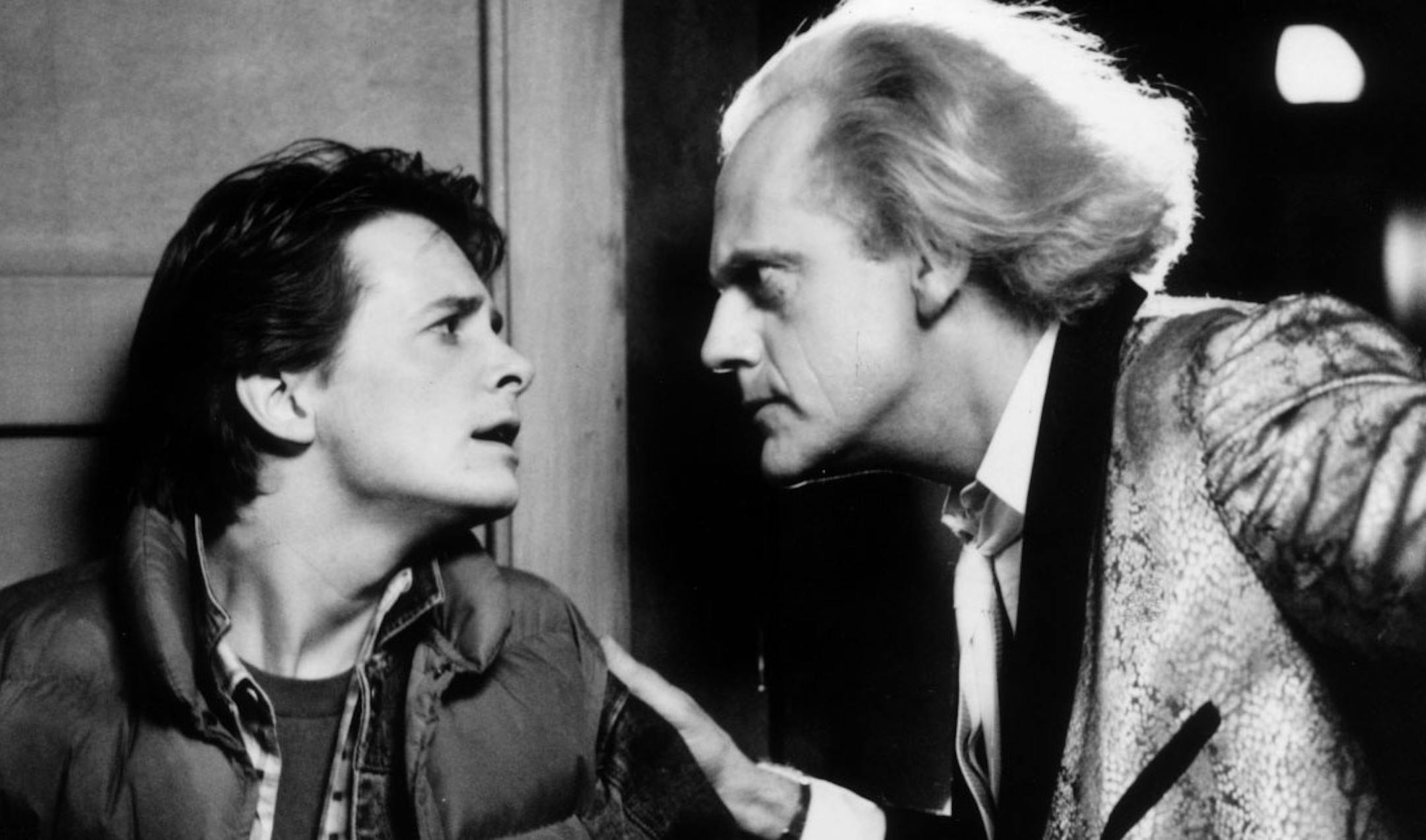 Michael J. Fox and Christopher Lloyd in the movie "Back to the Future", a Robert Zemeckis film. Time traveller Marty McFly (Michael J. Fox), stuck in the year 1955, tries to convince inventor Doc Brown (Christopher Lloyd) that he's from the year 1985.