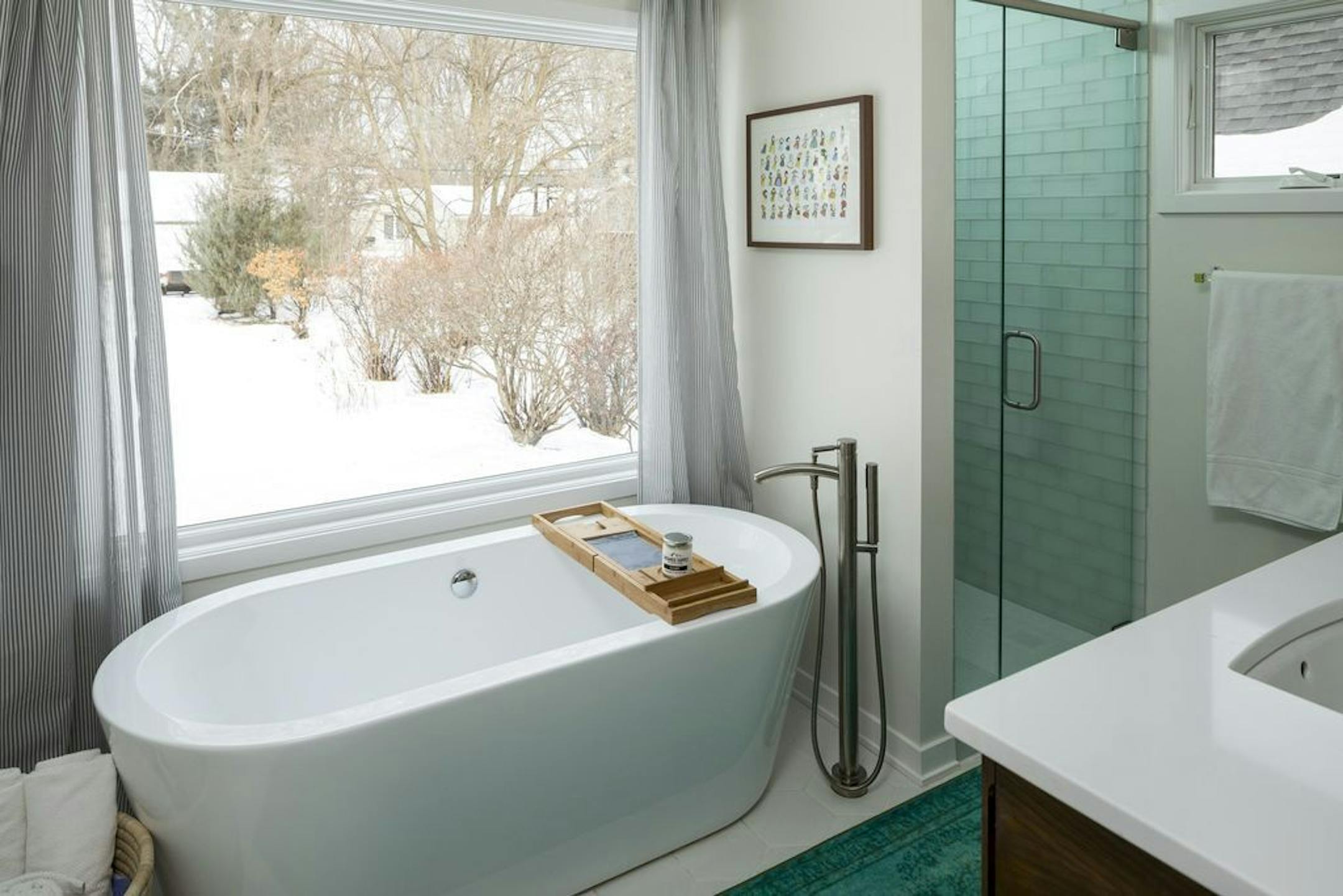 Owners' bathroom features a picture window above the soaking tub and floating vanity.