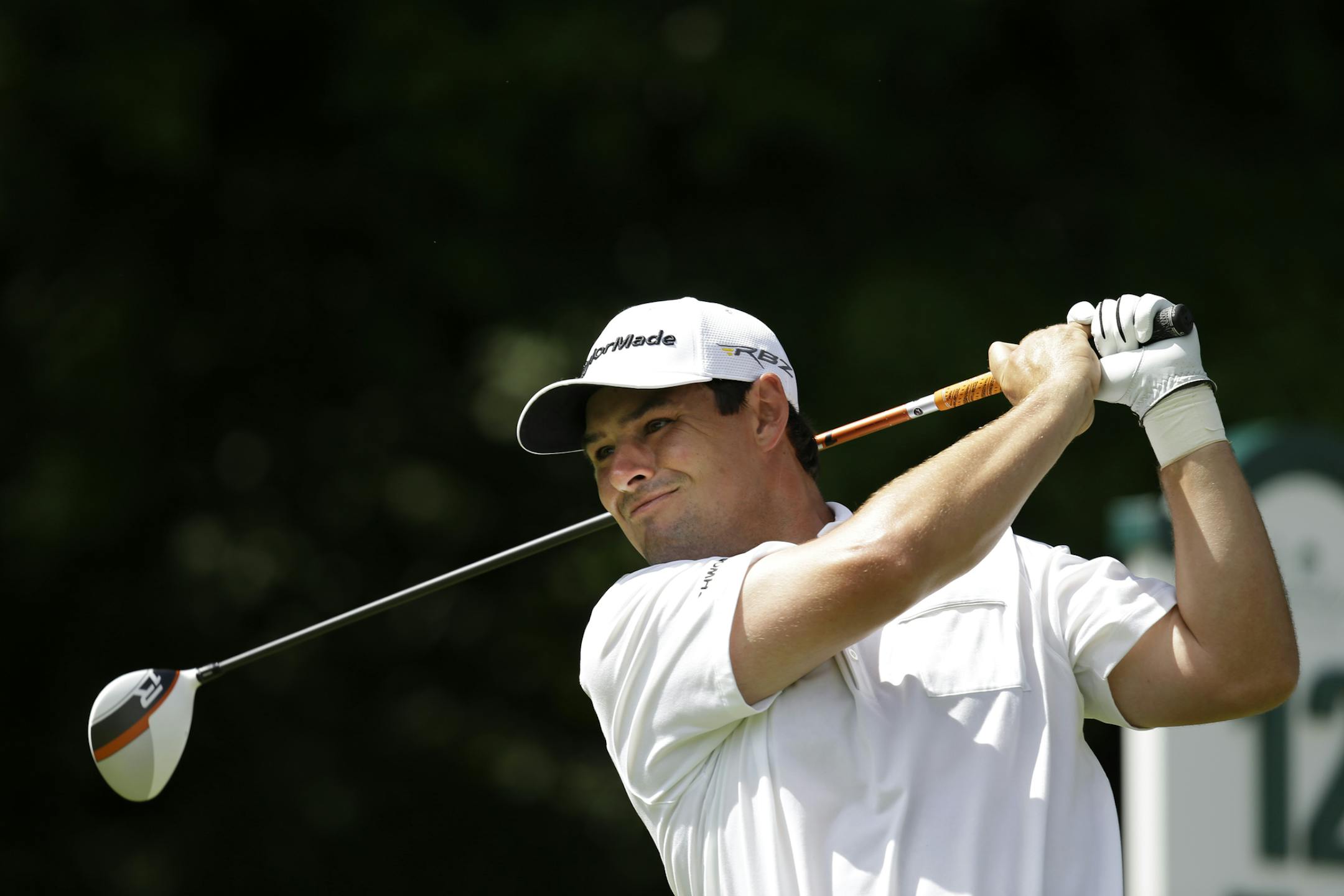 Johnson Wagner watches his tee shot on the 12th hole during the third round of the Greenbrier Classic PGA tour golf tournament at the Greenbrier in White Sulphur Springs, W.Va., Saturday, July 6, 2013. (AP Photo/Steve Helber)