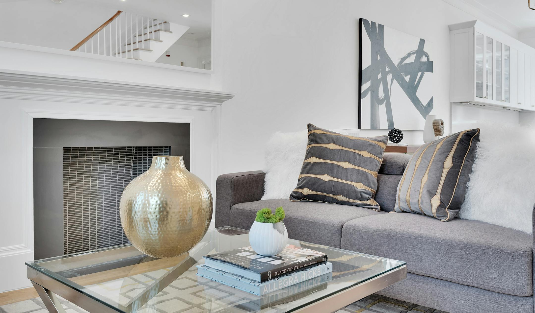 A small succulent has an understated touch when placed atop books in this modern living room. (Design Recipes) ORG XMIT: 1217410