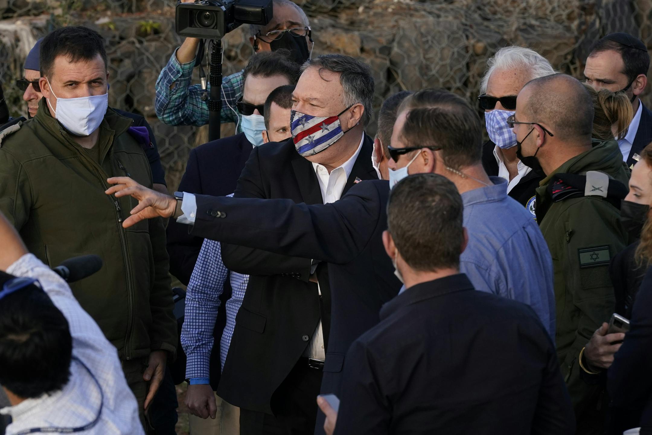 Secretary of State Mike Pompeo, center, listens during a security briefing on Mount Bental in the Israeli-controlled Golan Heights, overlooking the Israeli-Syrian border on Thursday.