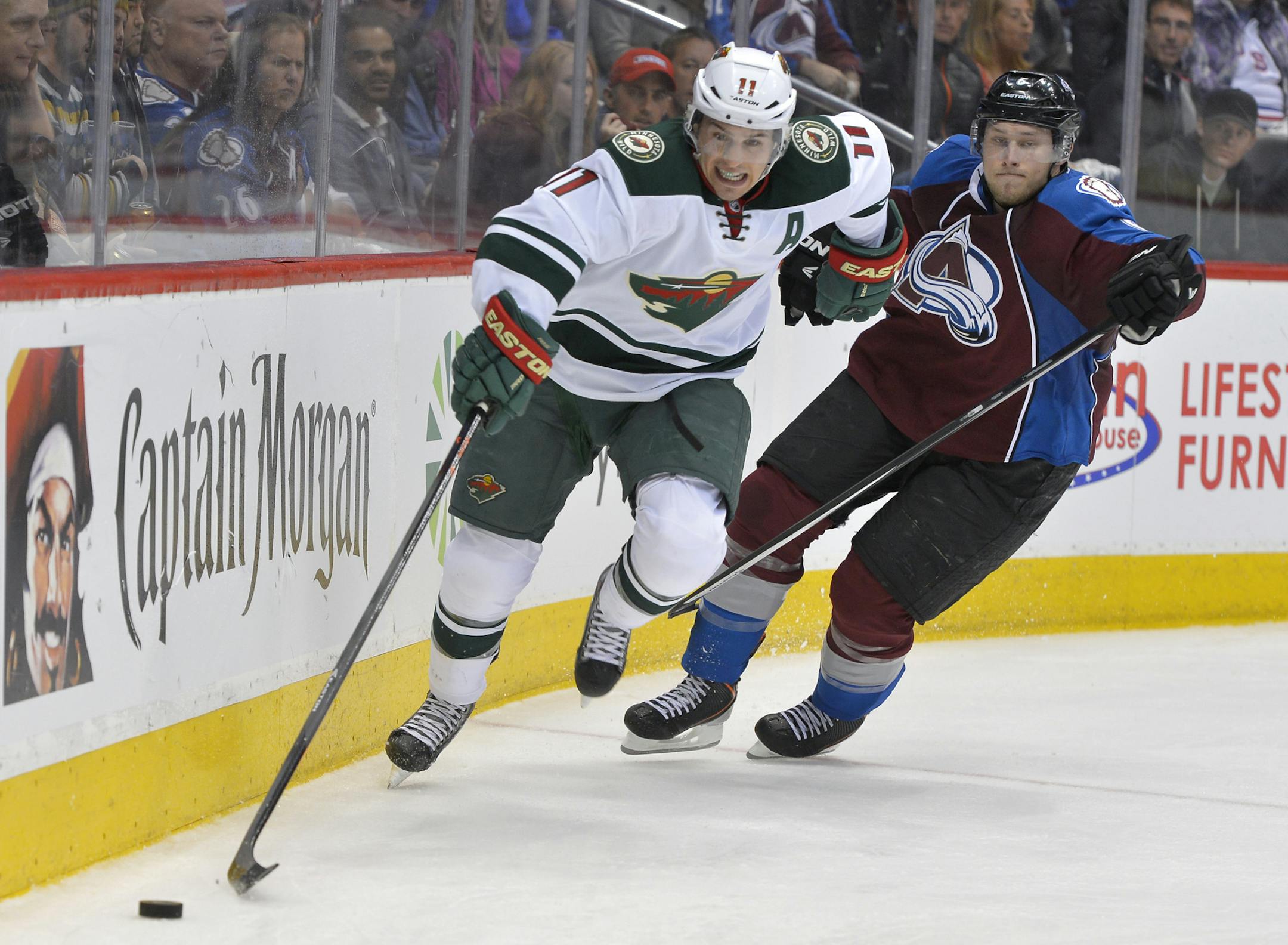 Minnesota Wild left wing Zach Parise (11) and Colorado Avalanche defenseman Erik Johnson (6) skate during the third period in Game 1 of an NHL hockey first-round playoff series on Thursday, April 17, 2014, in Denver. (AP Photo/Jack Dempsey) ORG XMIT: otk