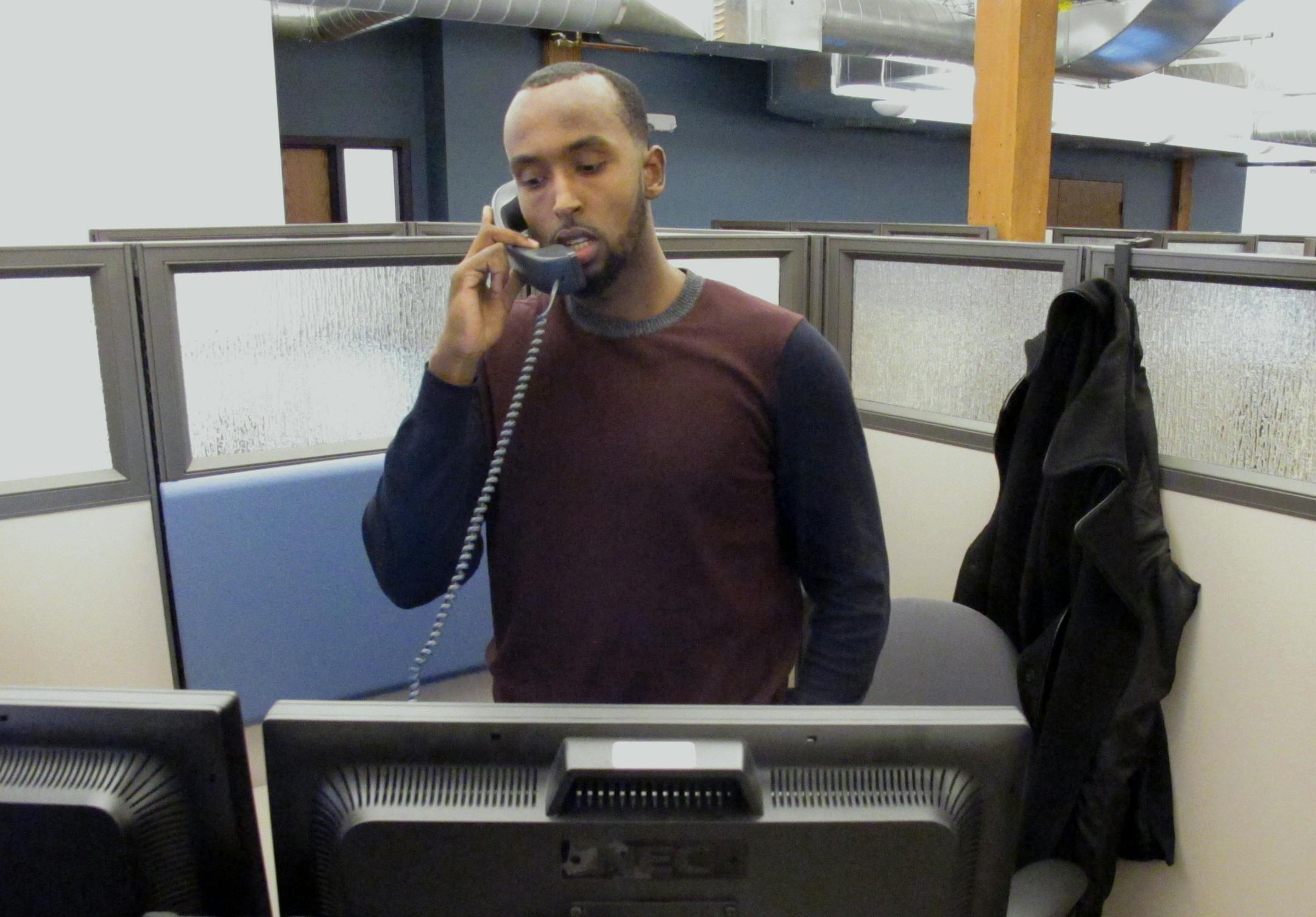 MNsure call center worker Yusuf Abdi fields calls from customers as open enrollment began for Minnesota's health insurance exchange Saturday, Nov. 15, 2014, in St. Paul, Minn. MNsure officials said the launch of the overhauled system went successfully. (AP Photo/Steve Karnowski)