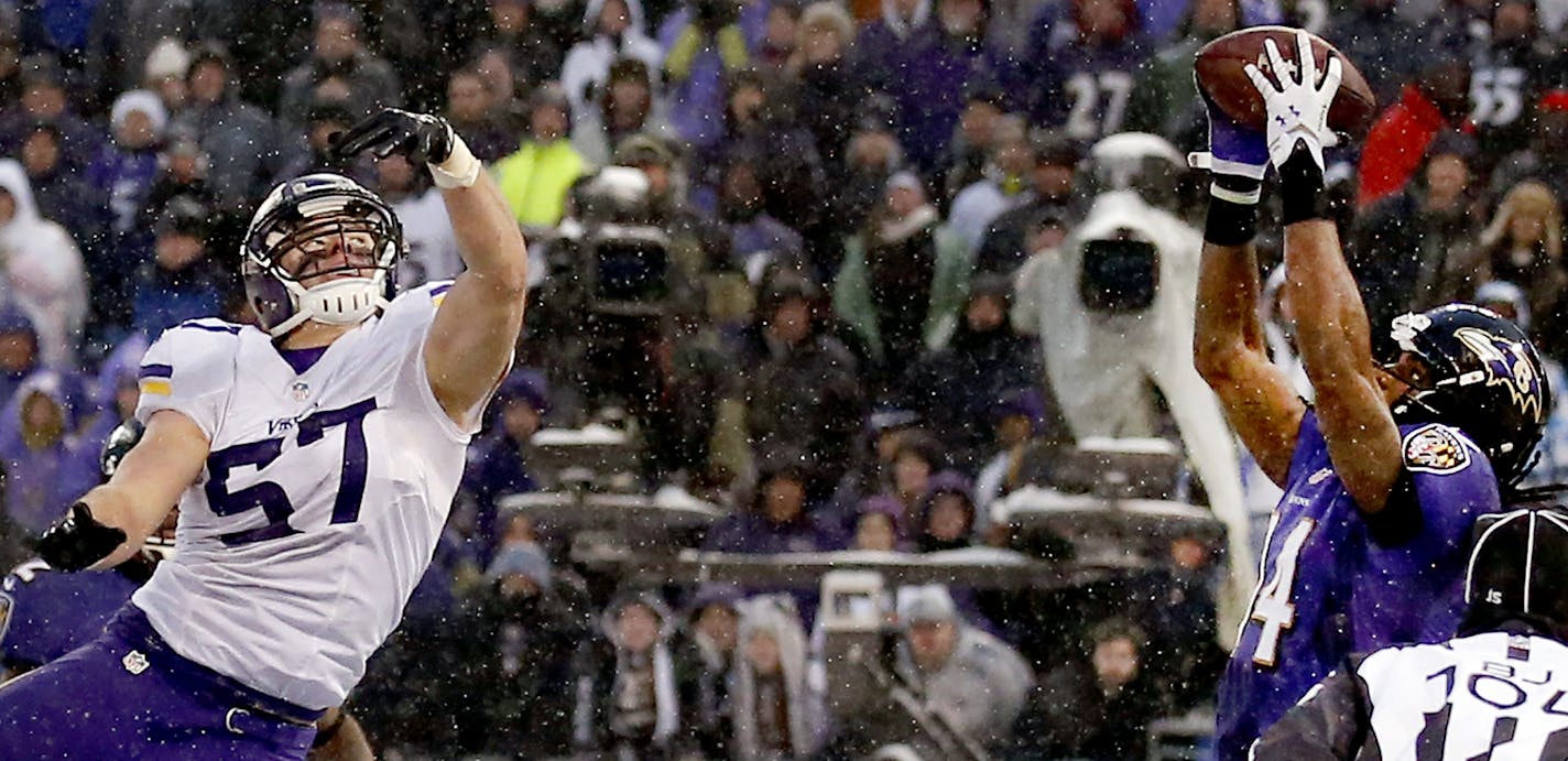 Marlon Brown (14) caught a touchdown pass while being defended by Audie Cole (57) in the final seconds of the fourth quarter to give the Ravens the lead. Baltimore beat Minnesota 29-26.