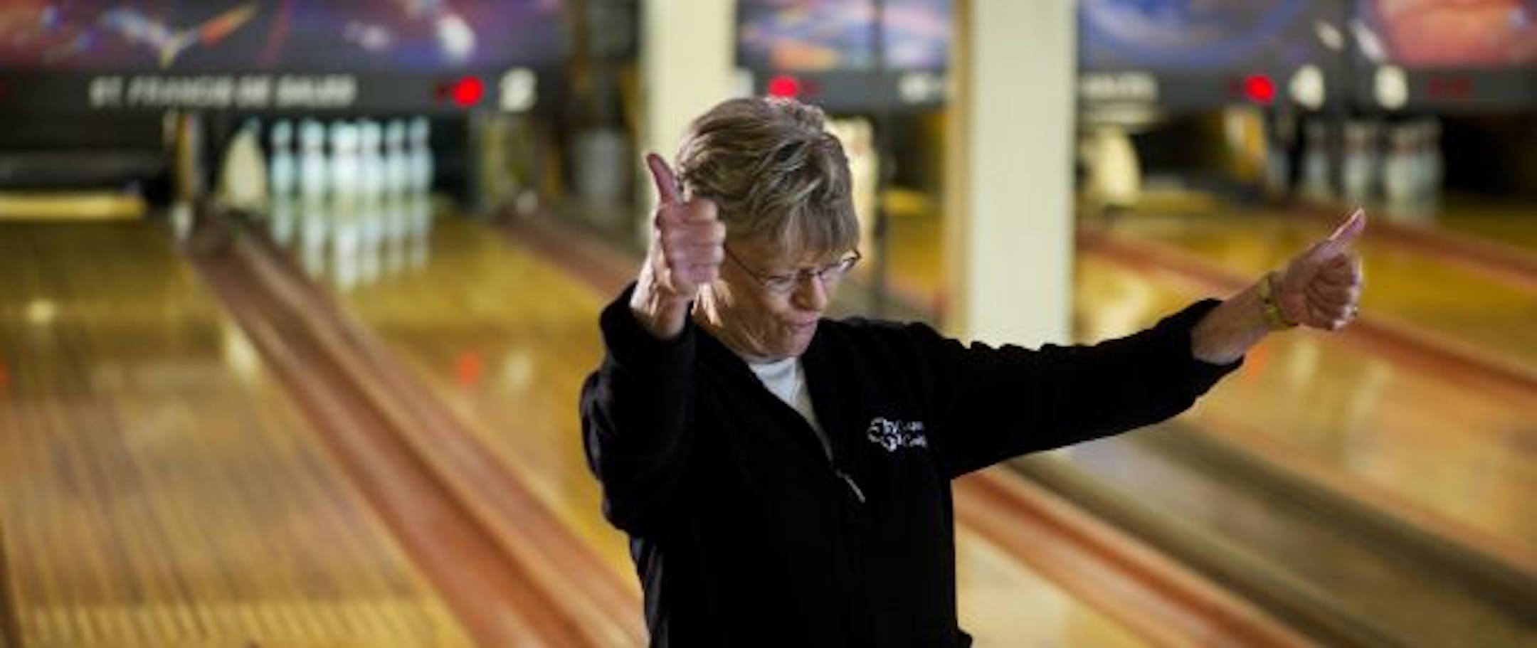 Diana Tschida celebrated getting a strike at the bowling alley run by St. Francis de Sales Church. She knows the place well; when she was in grade school, her brother worked as a pinsetter there.