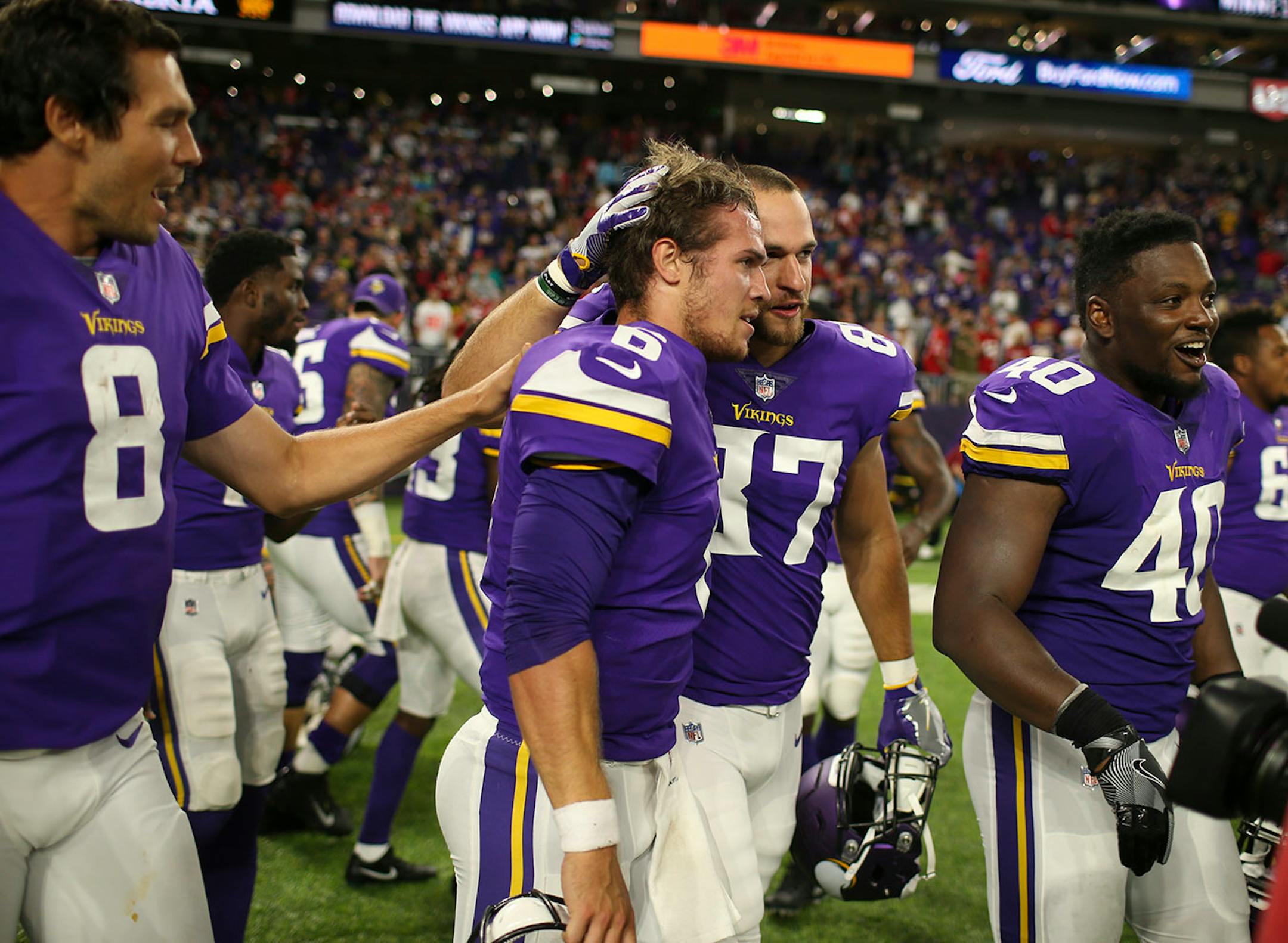 Minnesota Vikings quarterback Taylor Heinicke (6) was congratulated by teammates after he won the game with a successful run around the right end on a two point conversion.