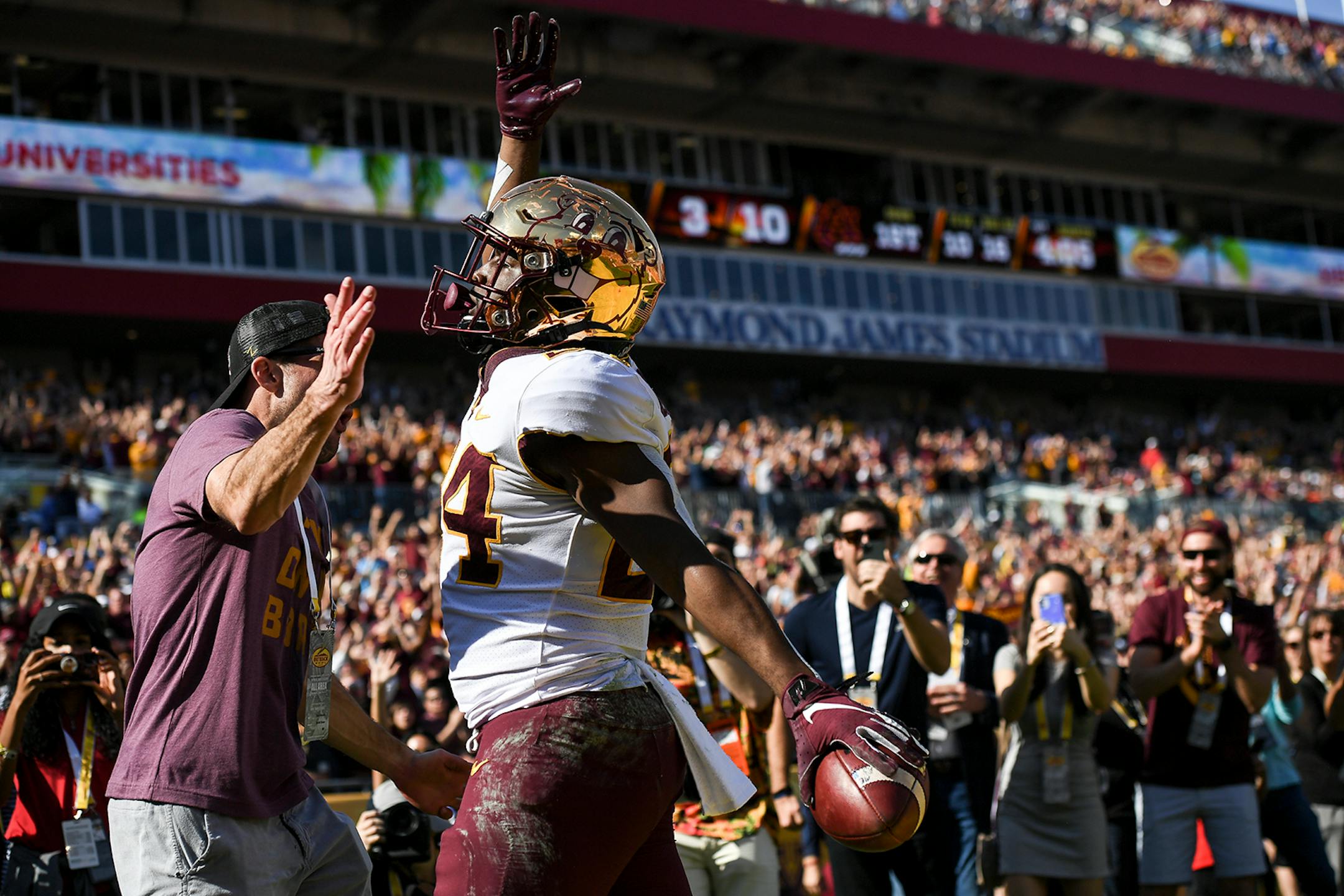 Minnesota Gophers running back Mohamed Ibrahim (24) celebrated after he rushed the ball for a touchdown in the first quarter against the Auburn Tigers.