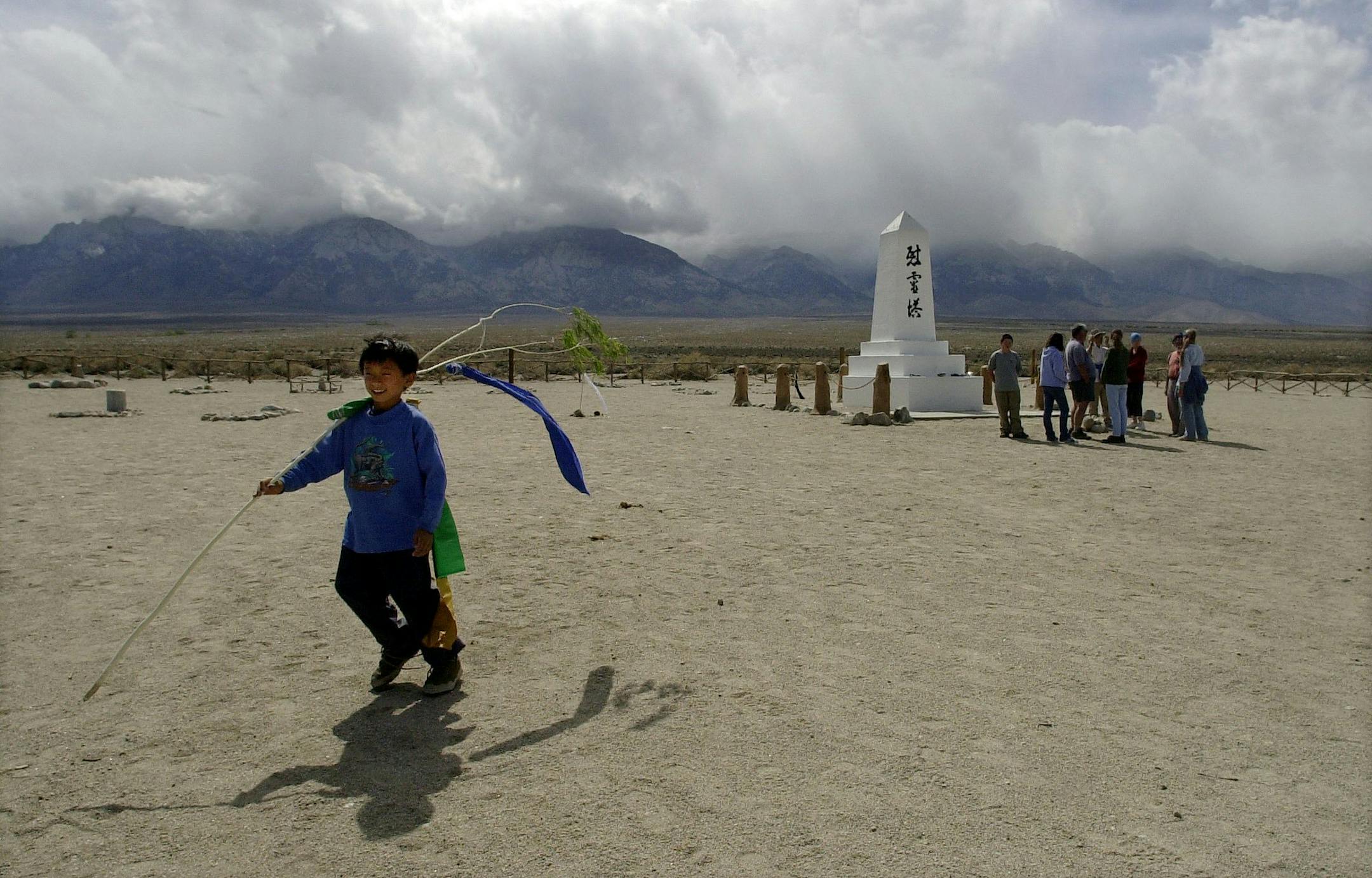 Morizo Nishida, 7, of Los Angeles, walks away after his family concludes a private prayer ceremony Friday April 26, 2002 at the Manzanar National Historic Landmark near Lone Pine, Calif. About 1,000 people are expected to take part in a pilgrimage Saturday at the site to mark the 60th anniversary of the order that sent Americans of Japanese descent to the internment camp at Manzanar and to other camps during World War II. (AP Photo/Joe Cavaretta) ORG XMIT: CAJC101