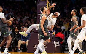 Lakers forward Anthony Davis reacts after getting hit in the eye by Wolves forward Kyle Anderson in the first half Sunday night in Los Angeles. Davis