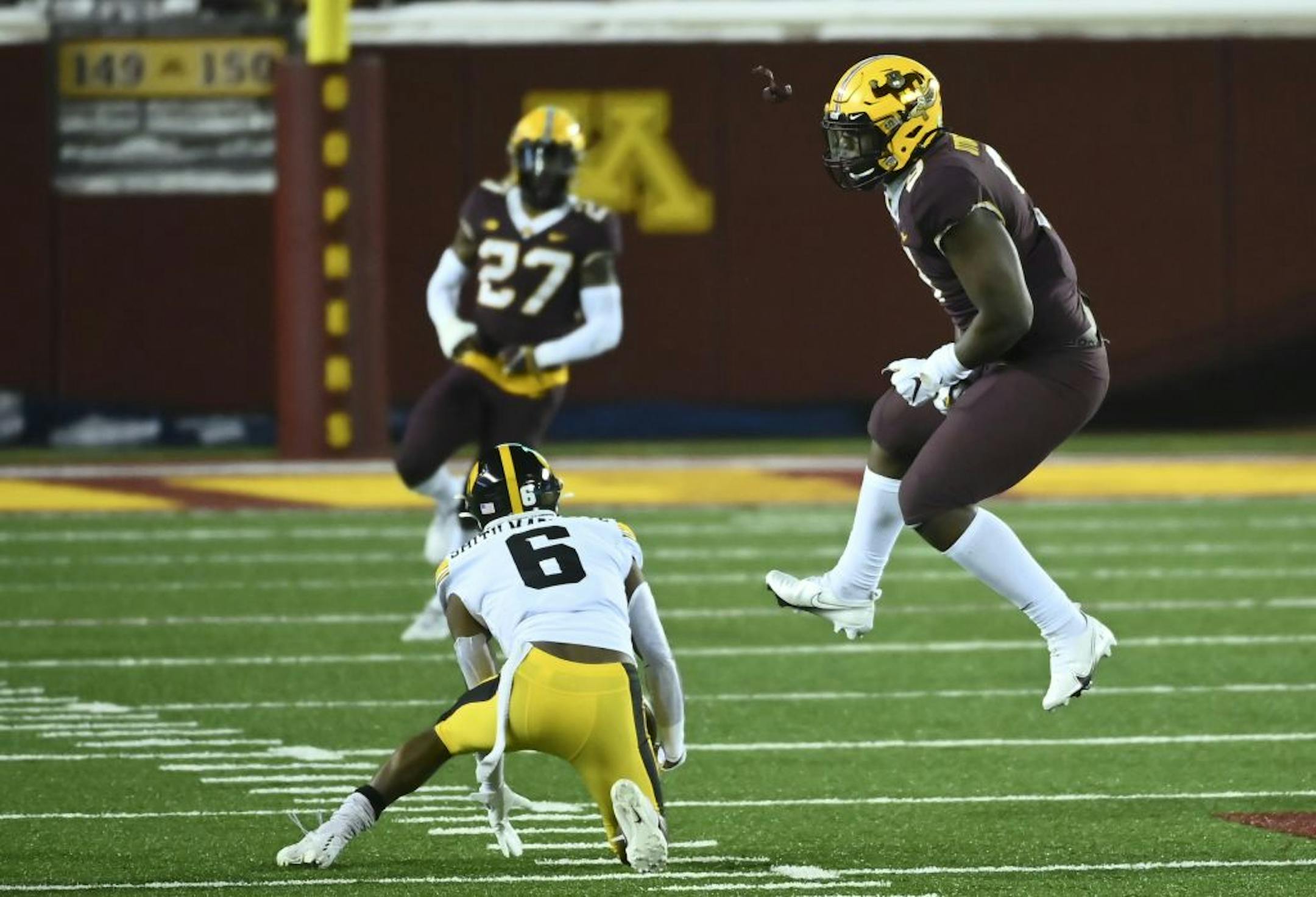 Minnesota Gophers defensive lineman Esezi Otomewo (9) celebrated after tackled Iowa Hawkeyes wide receiver Ihmir Smith-Marsette (6) for a loss of 6-yards in the second quarter.
