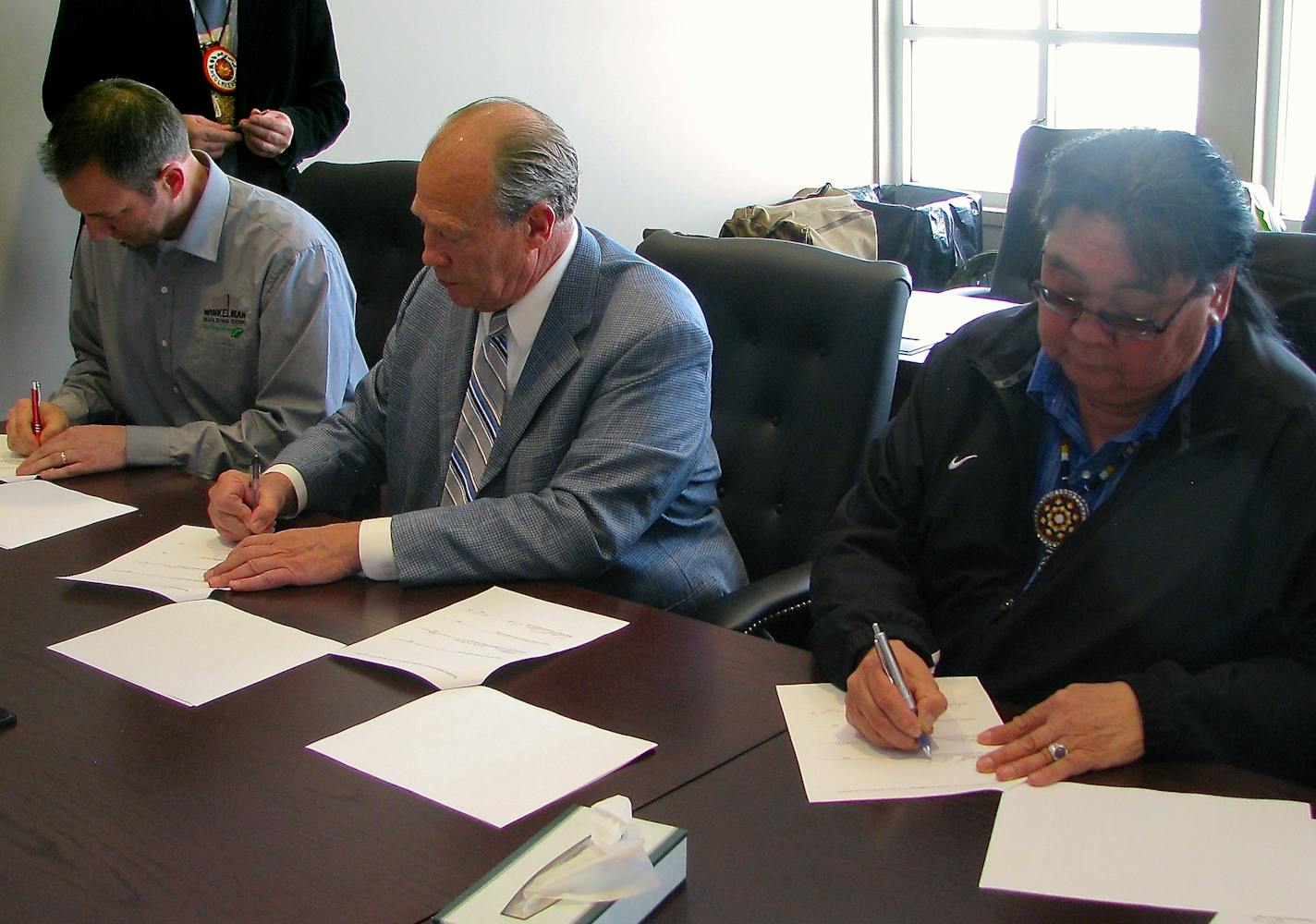 Mike Schoenecker of Winkelman Building Corp., tax lawyer Robert Olson of Olson Energy and Darrell G. Seki, Chairman of the Red Lake tribe signed a solar-development agreement earlier this year at the Red Lake tribal offices.