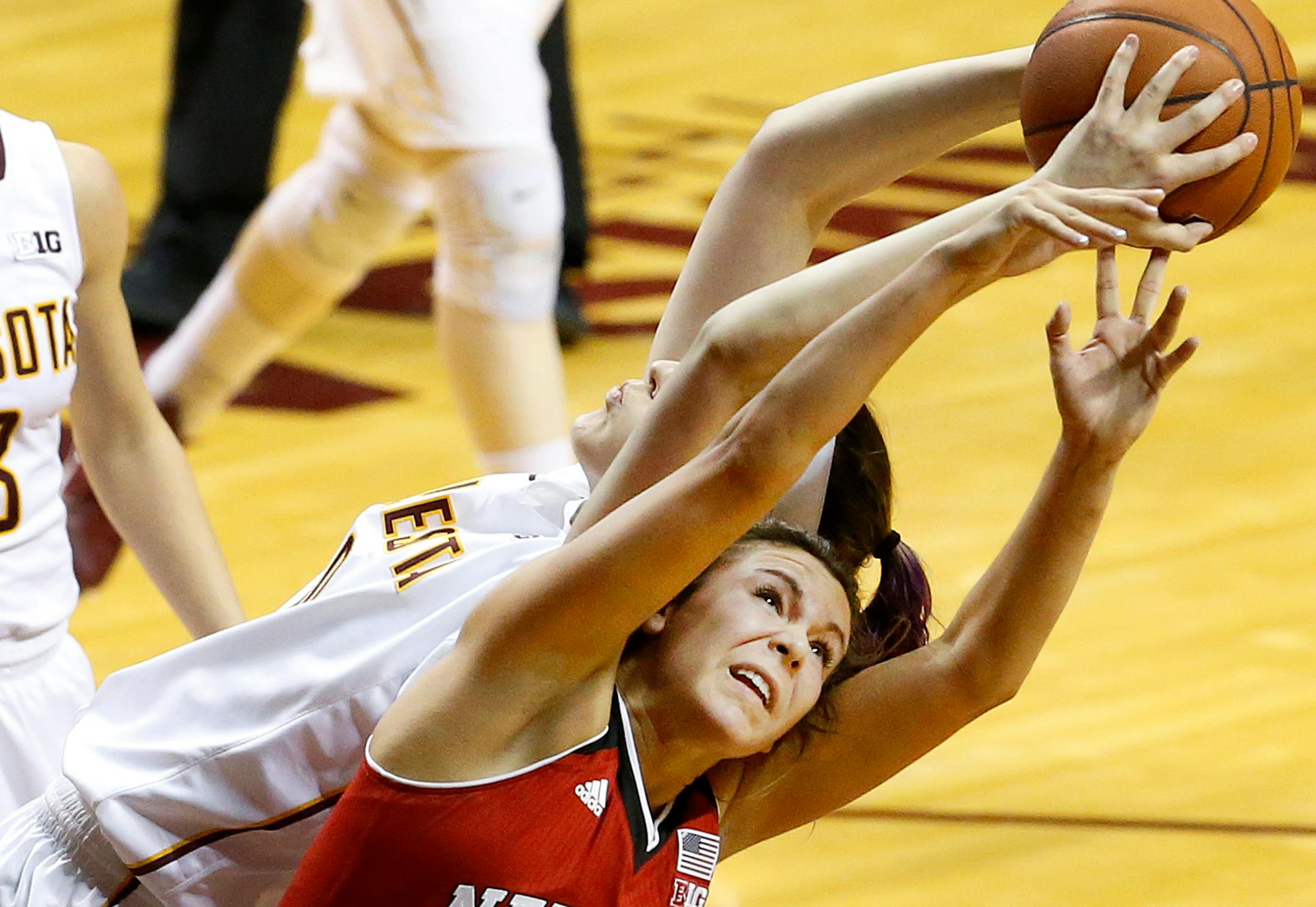 The Gophers' Jessie Edwards, left, and Nebraska's Natalie Romeo fought for a rebound in the second quarter Thursday night.