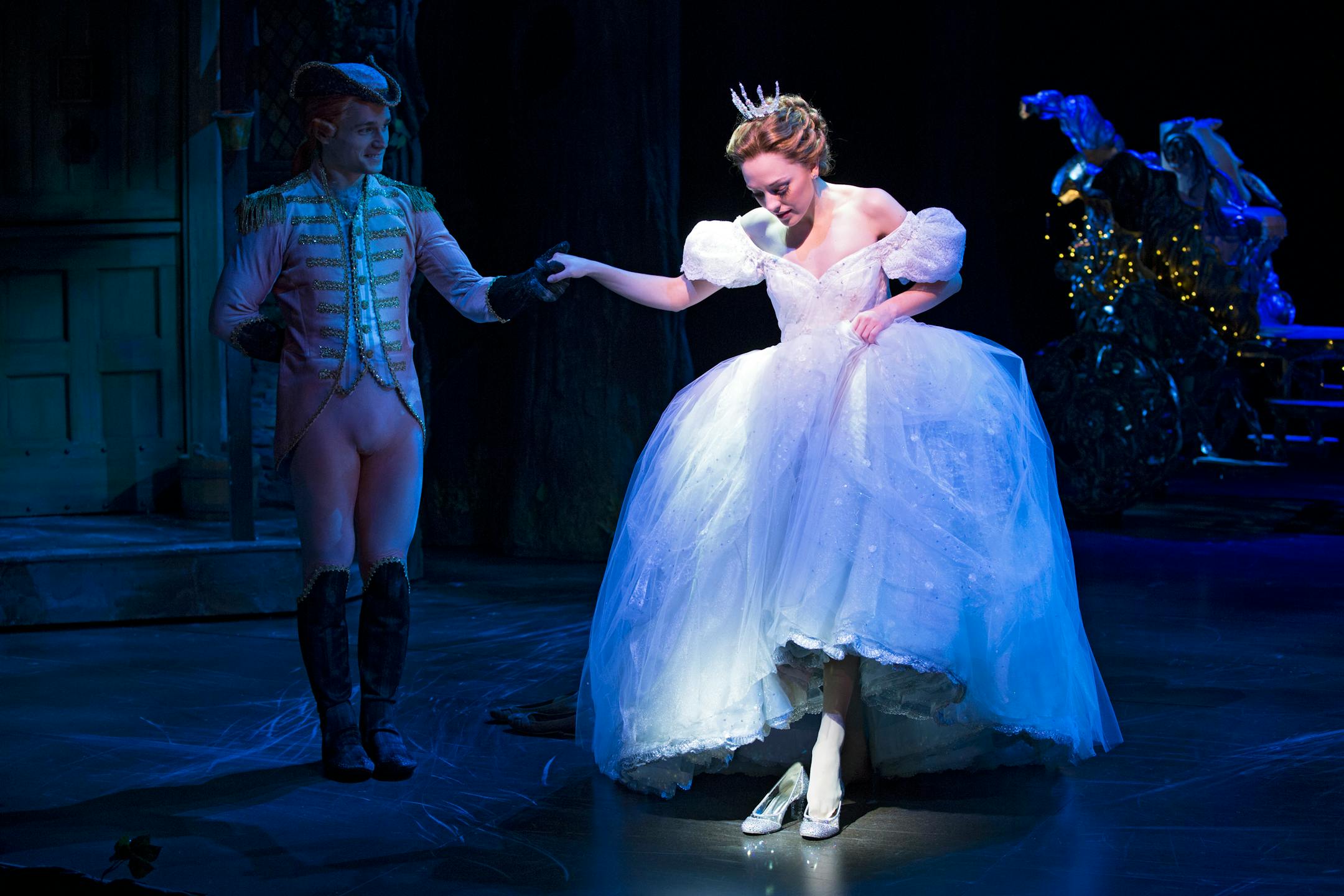This theater image released by Sam Rudy Media Relations shows Laura Osnes as Cinderella, slipping on glass slippers designed by Stuart Weitzman, during a performance of "Rodgers + Hammerstein's Cinderella on Broadway." Weitzman knows how to make shoes that make a splash. For years, he made the �million-dollar Oscar shoes,� diamond-covered footwear that a celebrity would wear to the Academy Awards. (AP Photo/Sam Rudy Media Relations, Carol Rosegg)