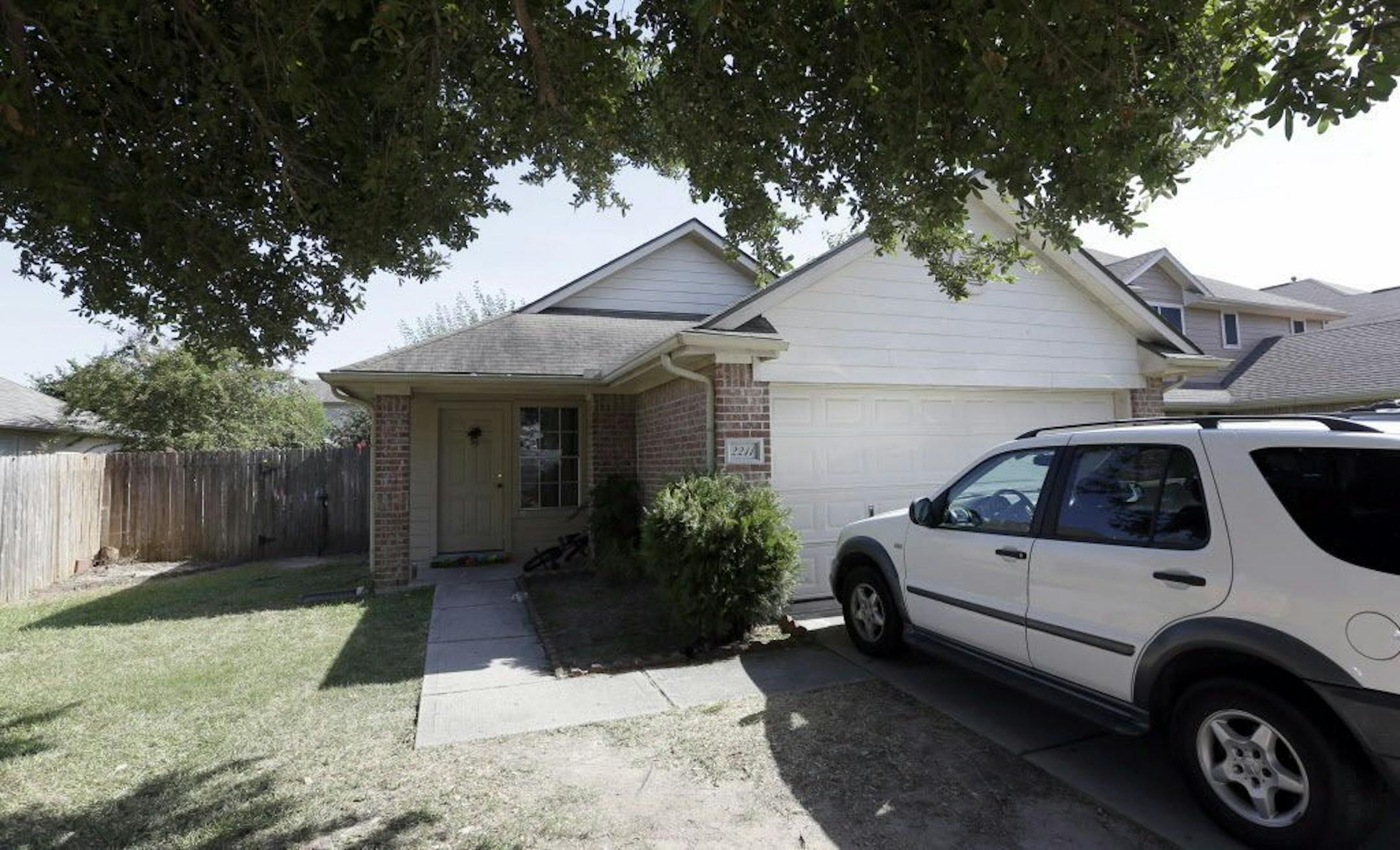 A house is shown, Sunday, Aug. 9, 2015, where eight people were killed on Saturday in Houston. A family of six children and two parents were handcuffed and fatally shot in the head at a Houston home by a man with a violent criminal history who had previously been in a relationship with the mother.