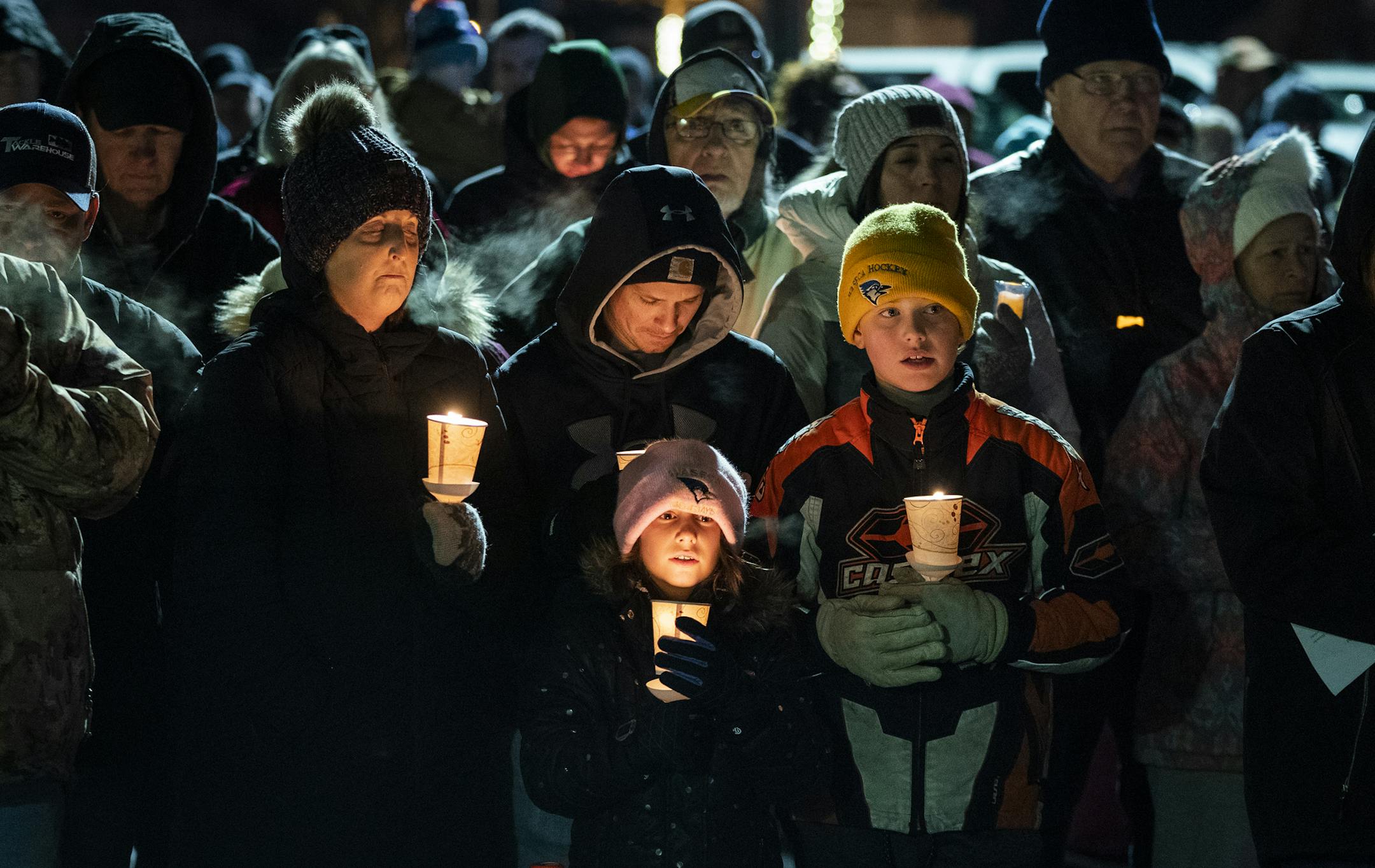 The Mann family of Waseca attended the candlelight vigil. From left is Callie Mann, her husband Dave and their children Emy, 9, and Jayden, 11. ] LEILA NAVIDI • leila.navidi@startribune.com BACKGROUND INFORMATION: Hundreds of people attended a candlelight vigil for Arik Matson, the Waseca police officer critically wounded in a shooting Monday night, outside the Waseca Public Safety Building in Waseca on Thursday, January 9, 2020.