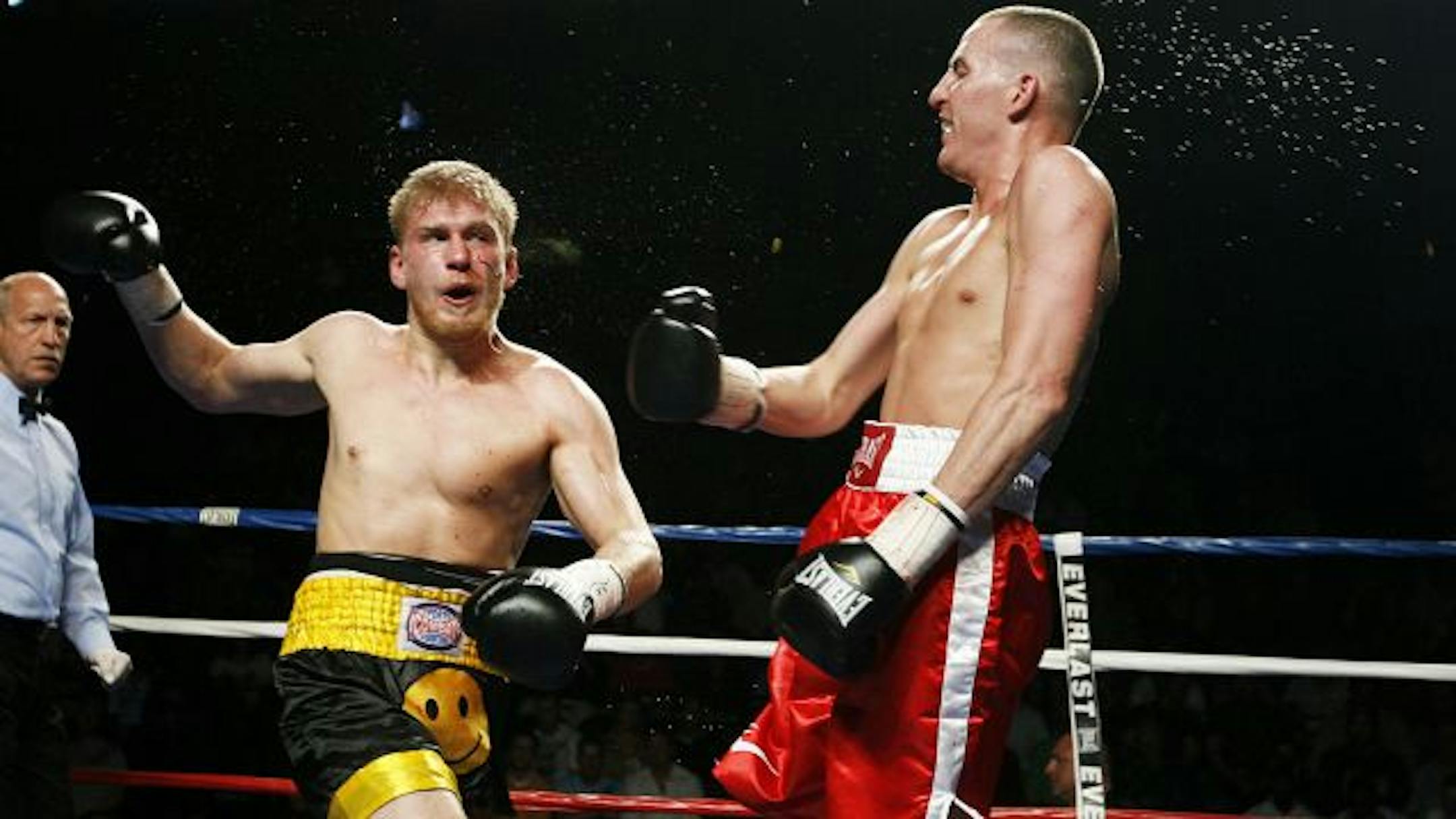 Sweat and punches fly as Junior middlewight fighters Don Tierney, right, and Zach Schumach fight during Fight Night at Target Center in Minneapolis. Tierney won by decision.