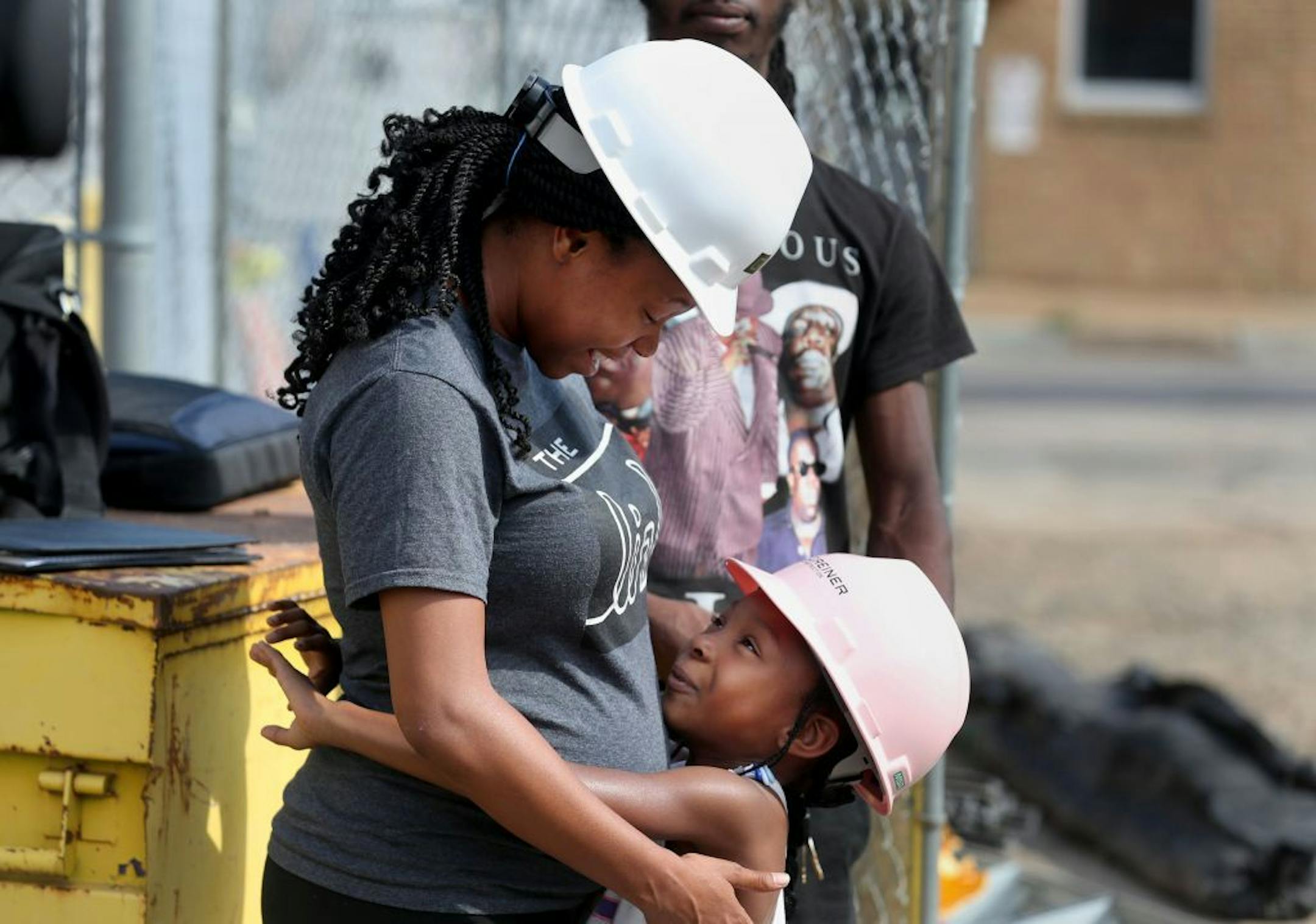 Hennepin County kicks off 100 day campaign to get 150 homeless youths permanent housing and jobs during a press conference at Youth Link Wednesday, Aug. 2, 2017, in Minneapolis, MN. Here, homeless off and on from age 15 to 20, Symmie, 23, (does not want last name known) and her daughter Zyaeriyau, 7, hugged prior to Symmie speaking at the press conference at Youth Link.