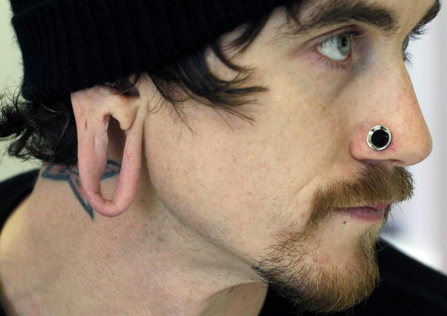 James Clark, who has been piercing ears for 15 years, and stretched his own lobes out to over 2 inches is now considering getting surgery to reduce the size of his lobes. [ TOM WALLACE � twallace@startribune.com _ Assignments # 20021562A_ January 17, 2011_ SLUG: ear0121_ EXTRA INFORMATION: Saint Sabrina's is the location where we took the photo.