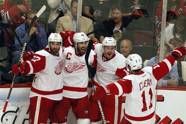 The Detroit Red Wings' Henrik Zetterberg, second from left, celebrates his third-period goal against the Chicago Blackhawks in Game 7 of Western Confe
